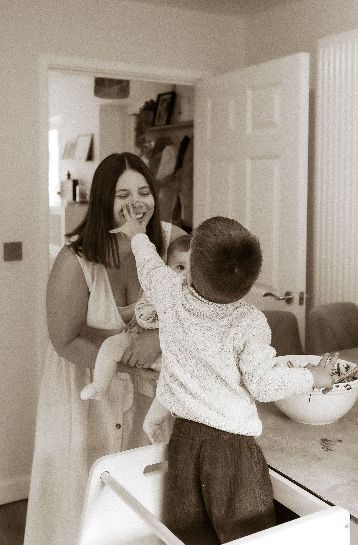 Storytelling Photoshoot of son getting cake chocolate on mums nose in Swinbrook Cotswolds.