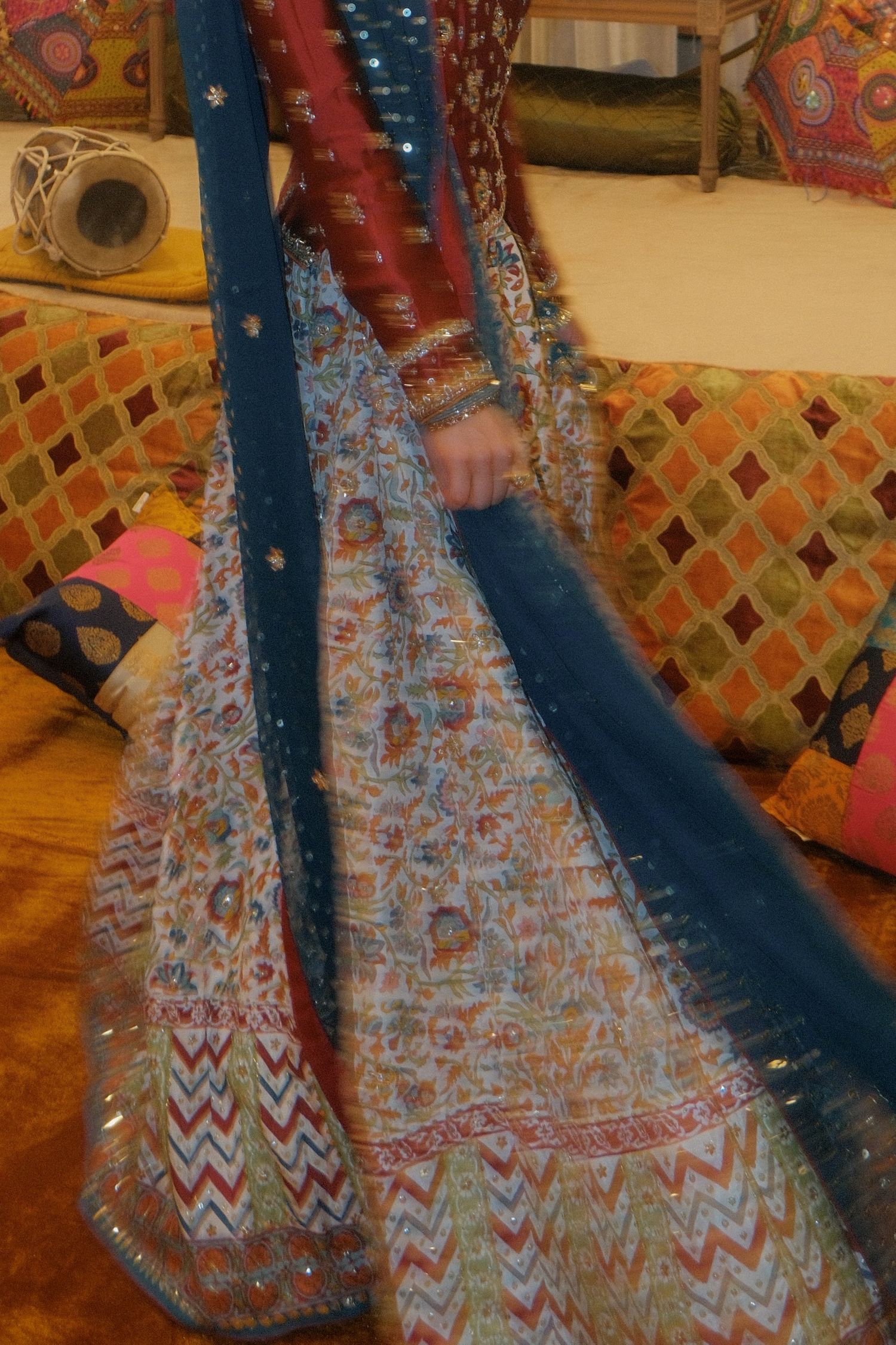 Colorful Pakistani bridal lehenga with blue dupatta featuring intricate embroidery and mirror work details.
