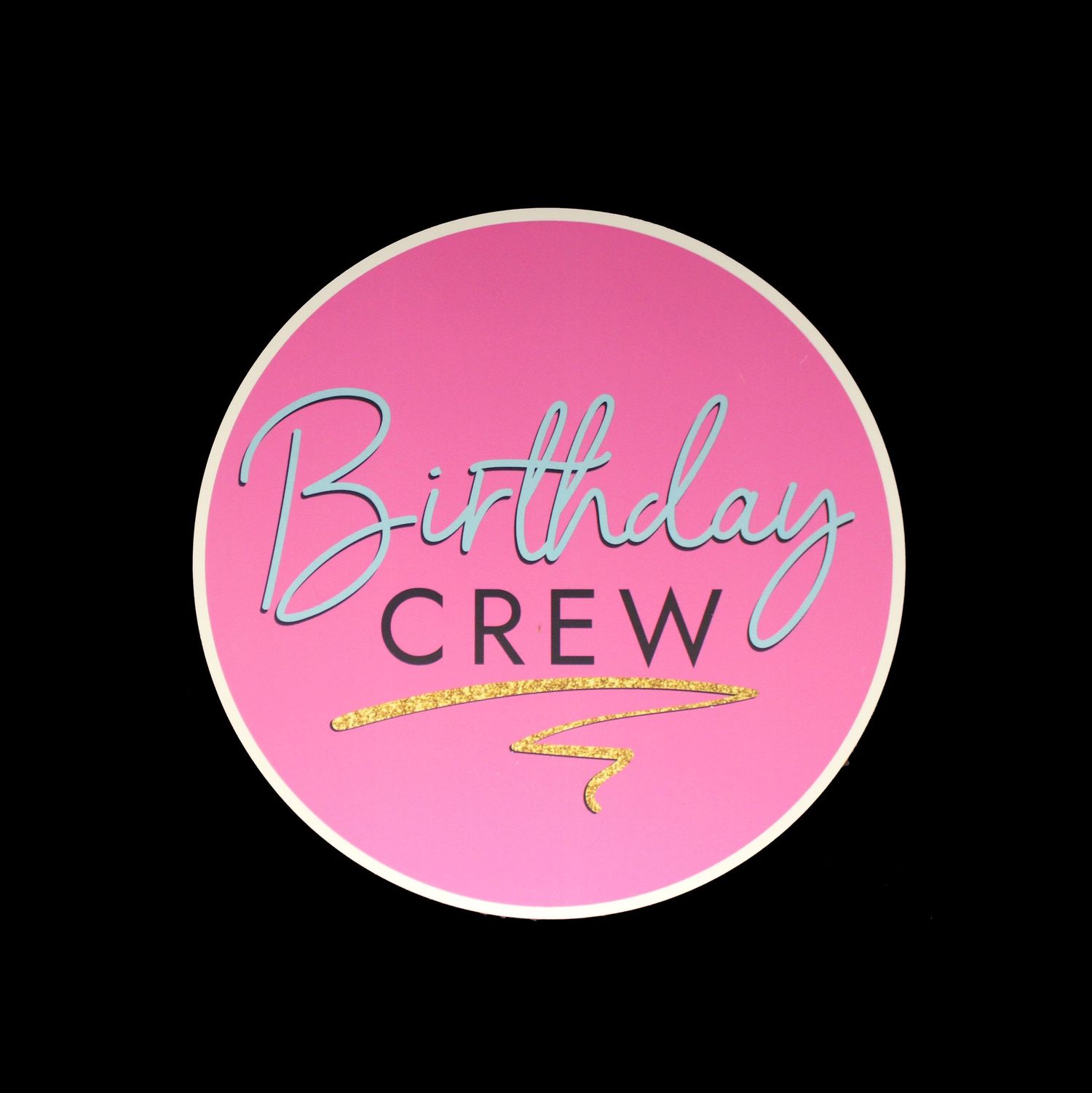 A vibrant pink circular Birthday Crew sticker with elegant script lettering and gold underline.