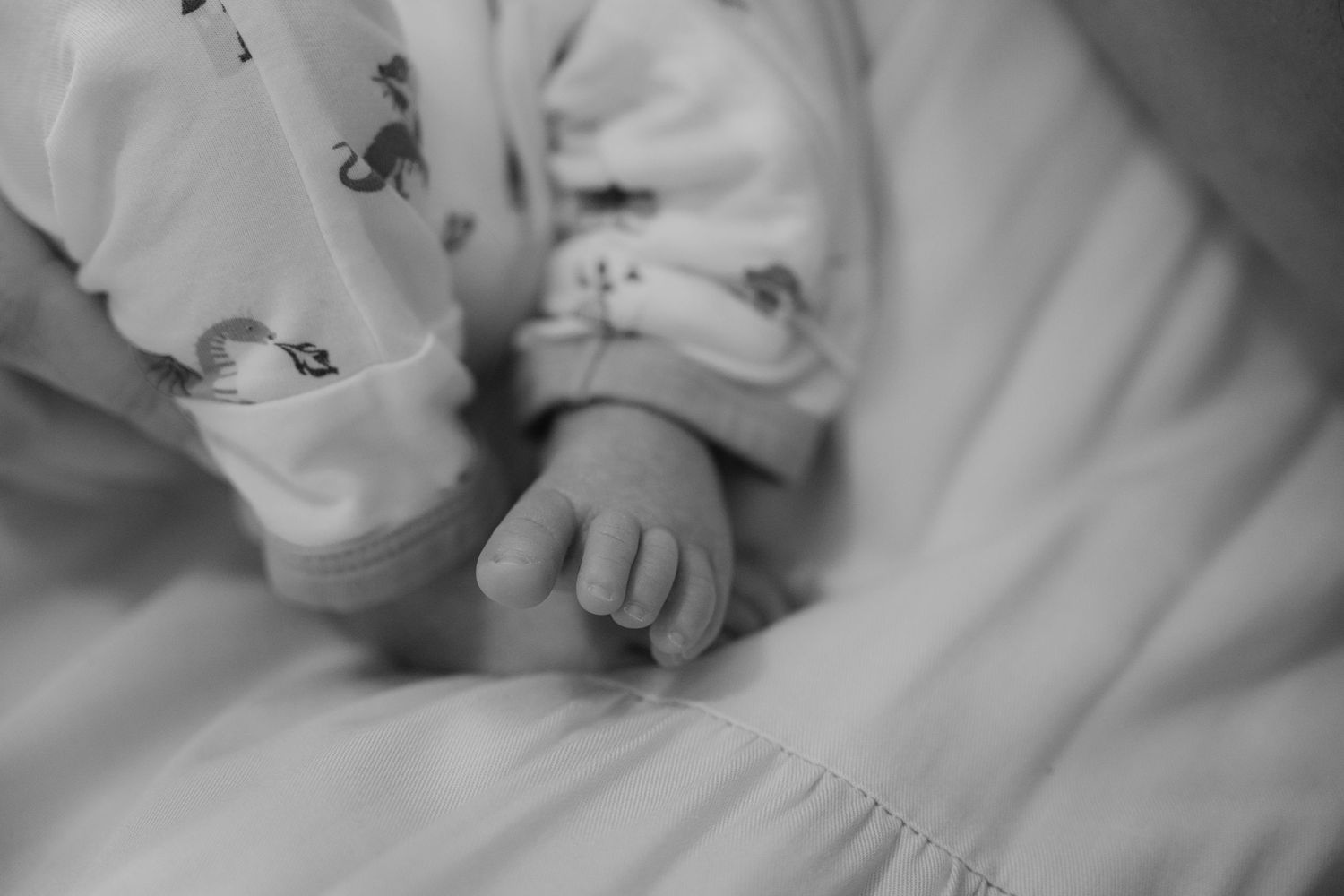 lifestyle Black and white close-up of a newborn baby's tiny toes