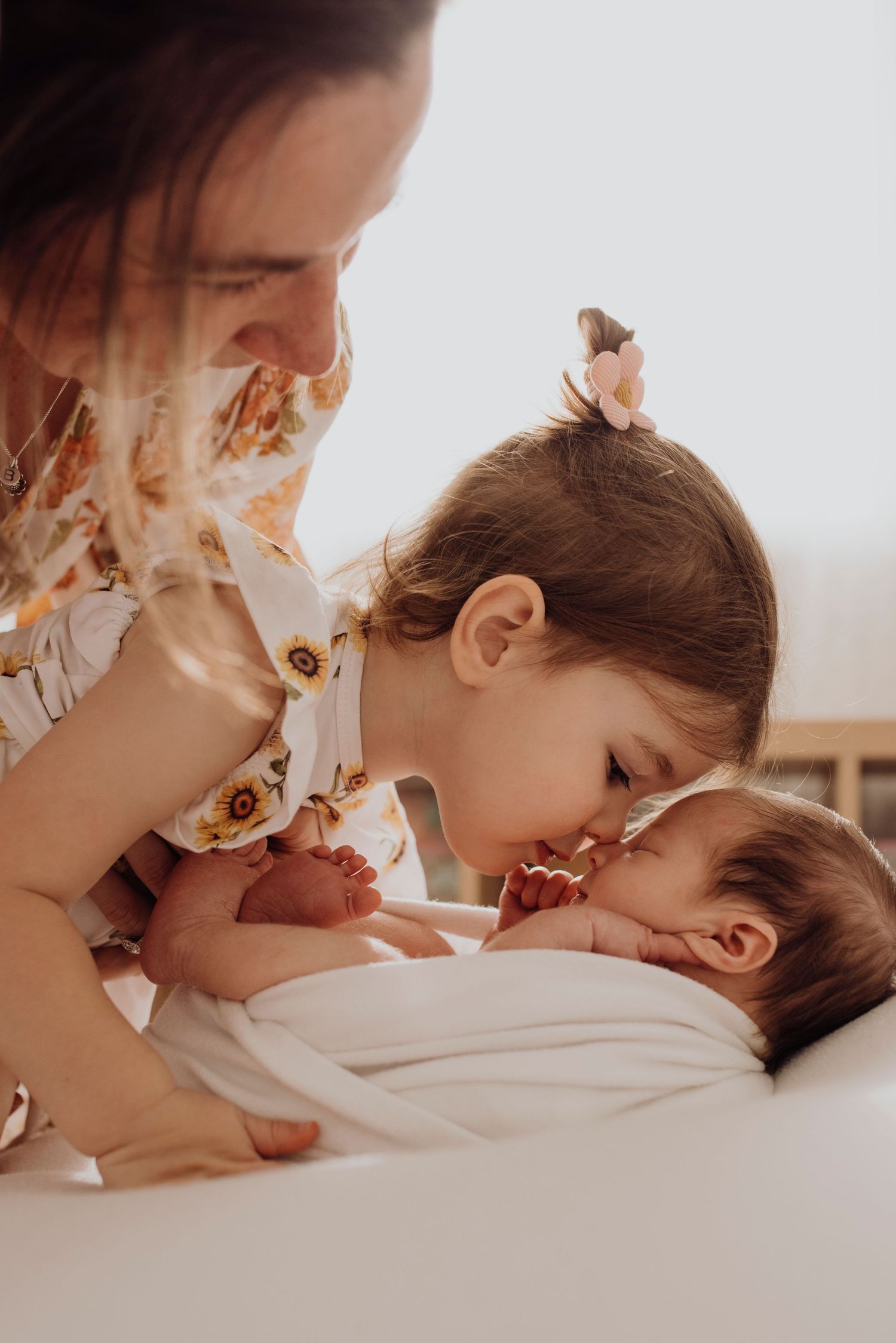 family newborn photography Sydney of sibling kissing newborn baby, tender connection