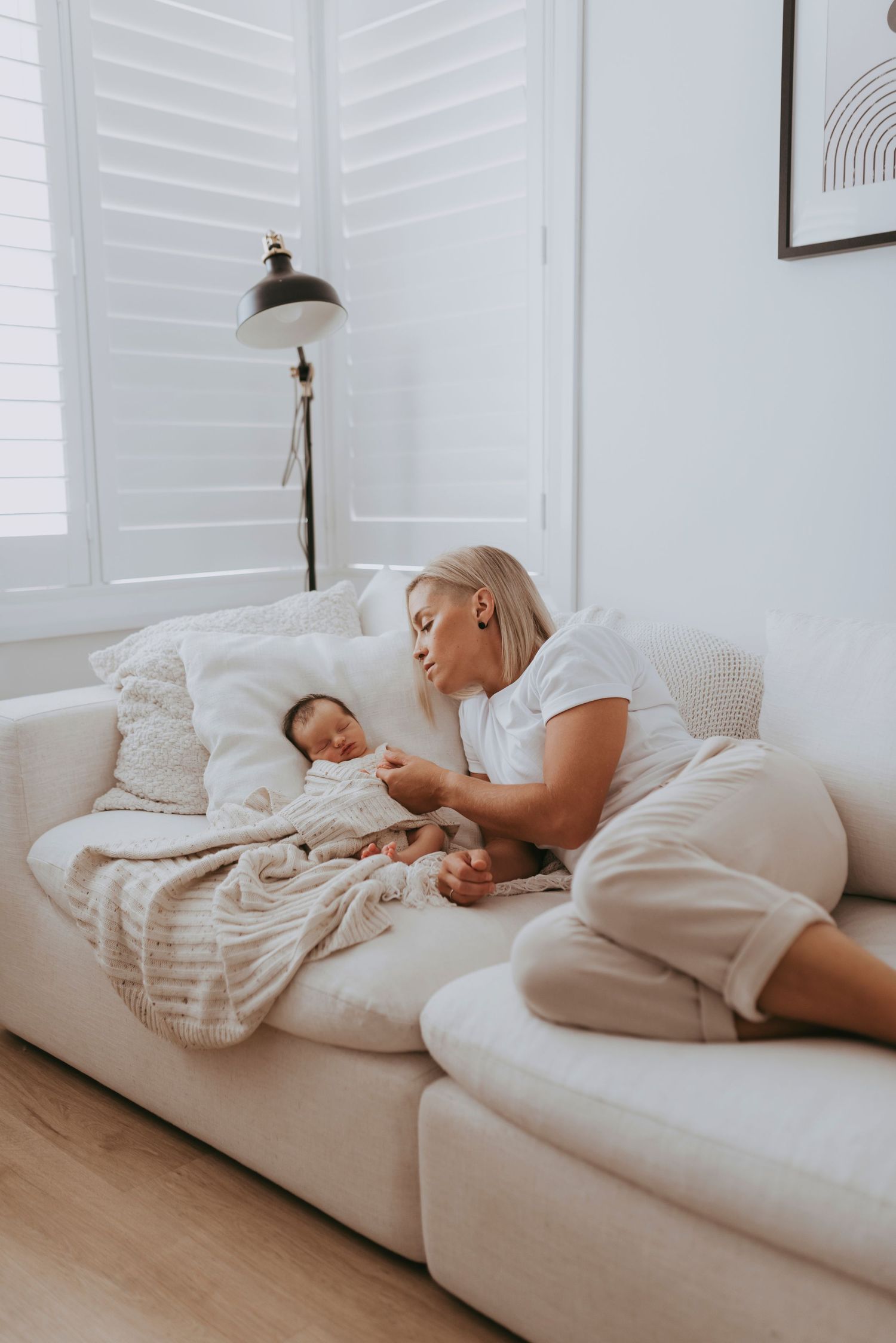 newborn photography Sydney in-home parents holding sleeping baby natural lifestyle session IVF success story two mums LGBTQ+