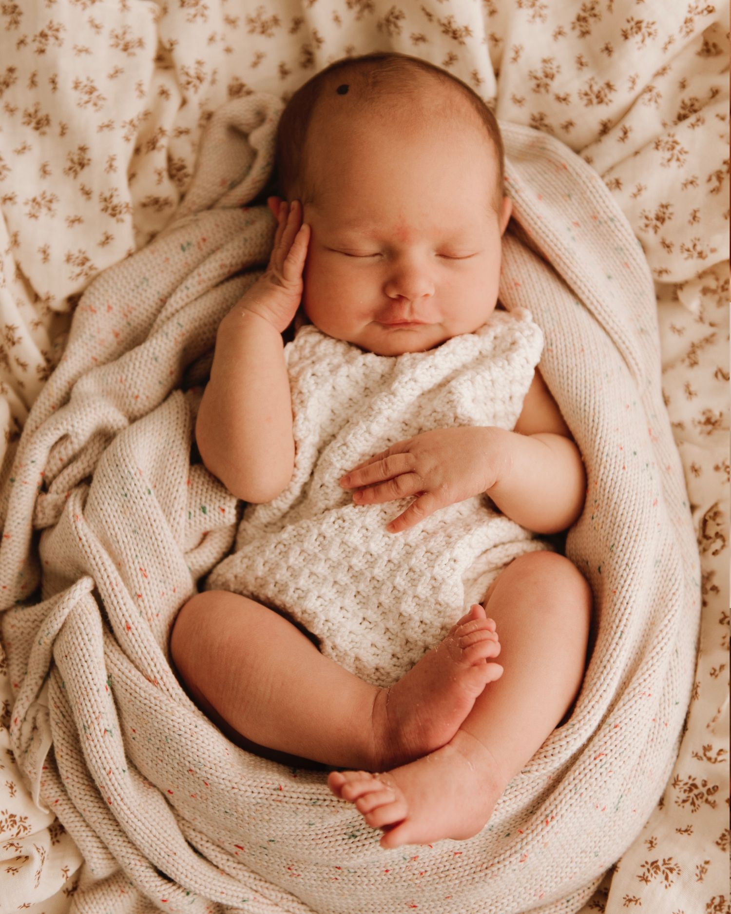 Sydney newborn photography of baby lying wrapped in soft neutral tones. IVF success after endometriosis