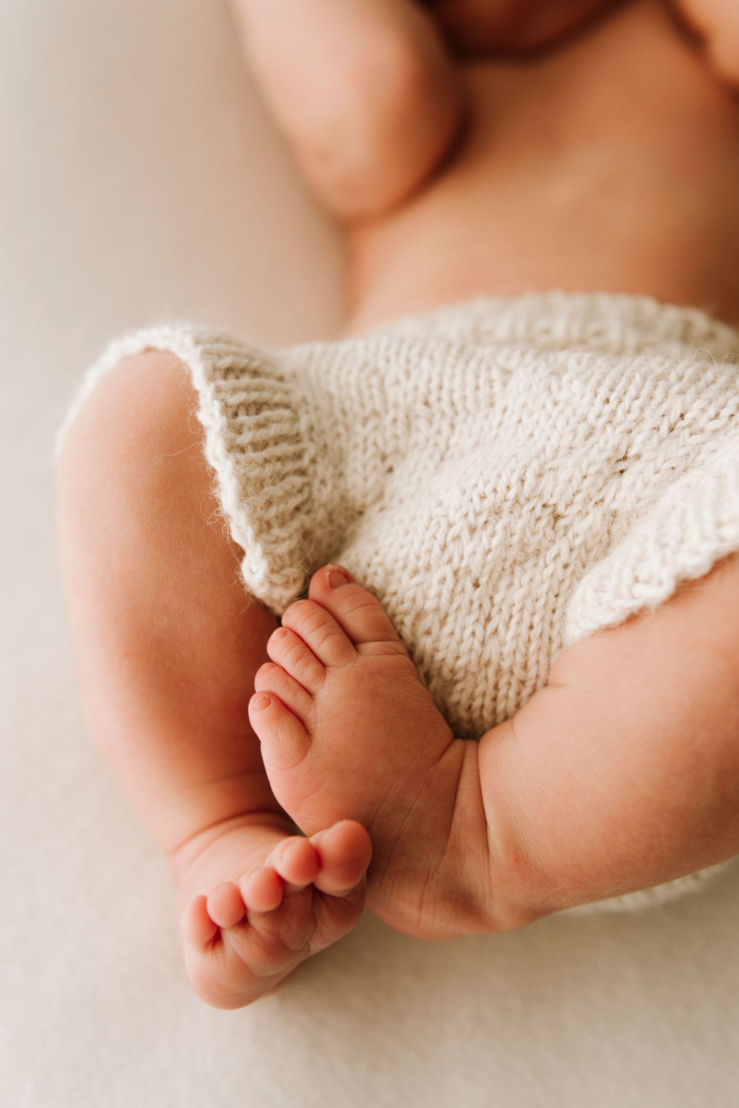 Rose Bay newborn photography detail of baby legs wrapped in soft knit outfit