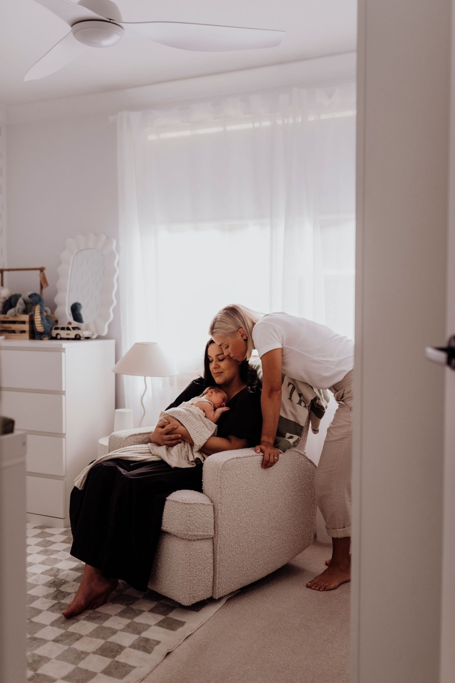 in-home newborn photography Sydney of family with newborn baby in nursery during relaxed home photoshoot