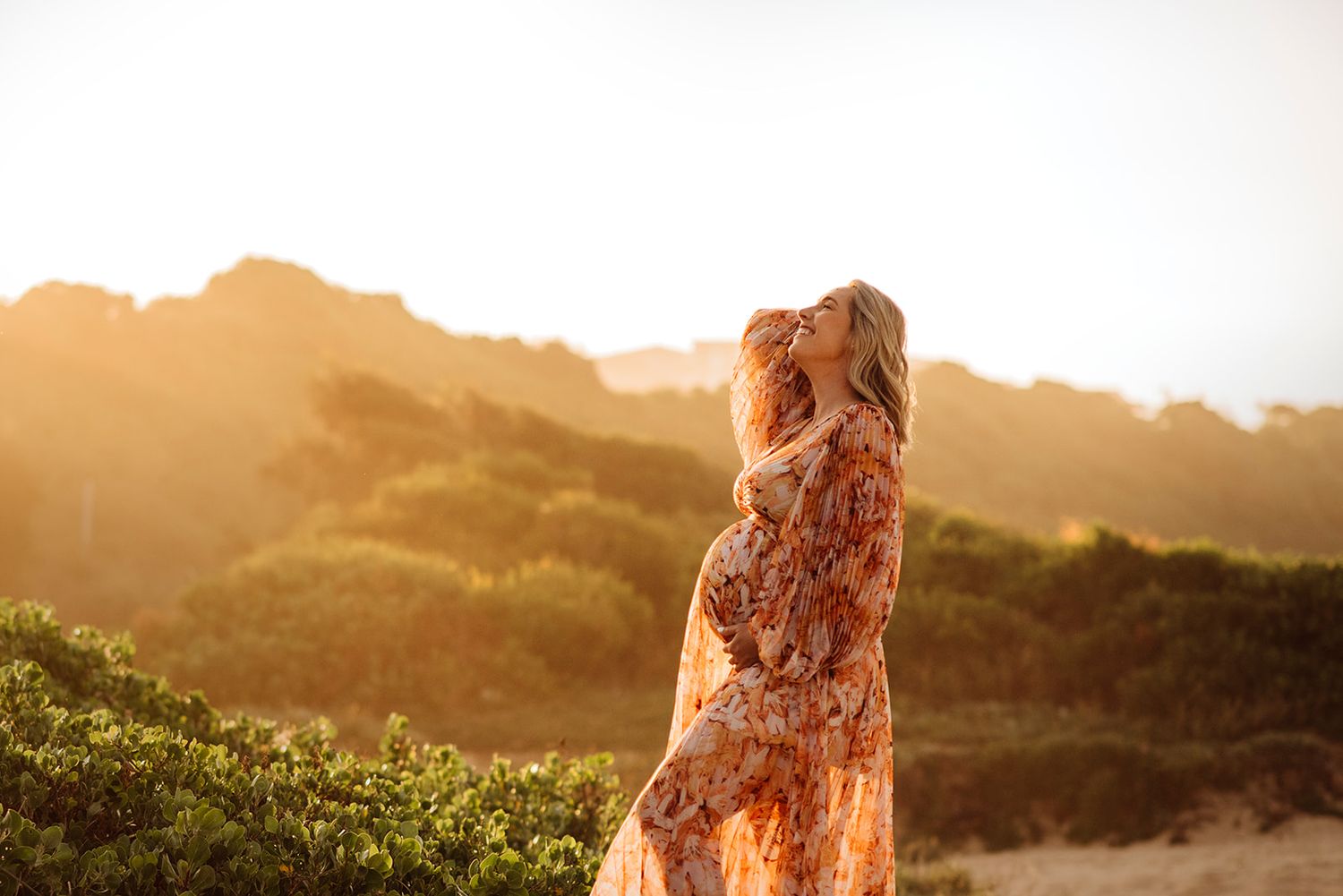 pregnant woman at sunset beach maternity photography Maroubra Sydney natural light. wearing dress from Mamarentals