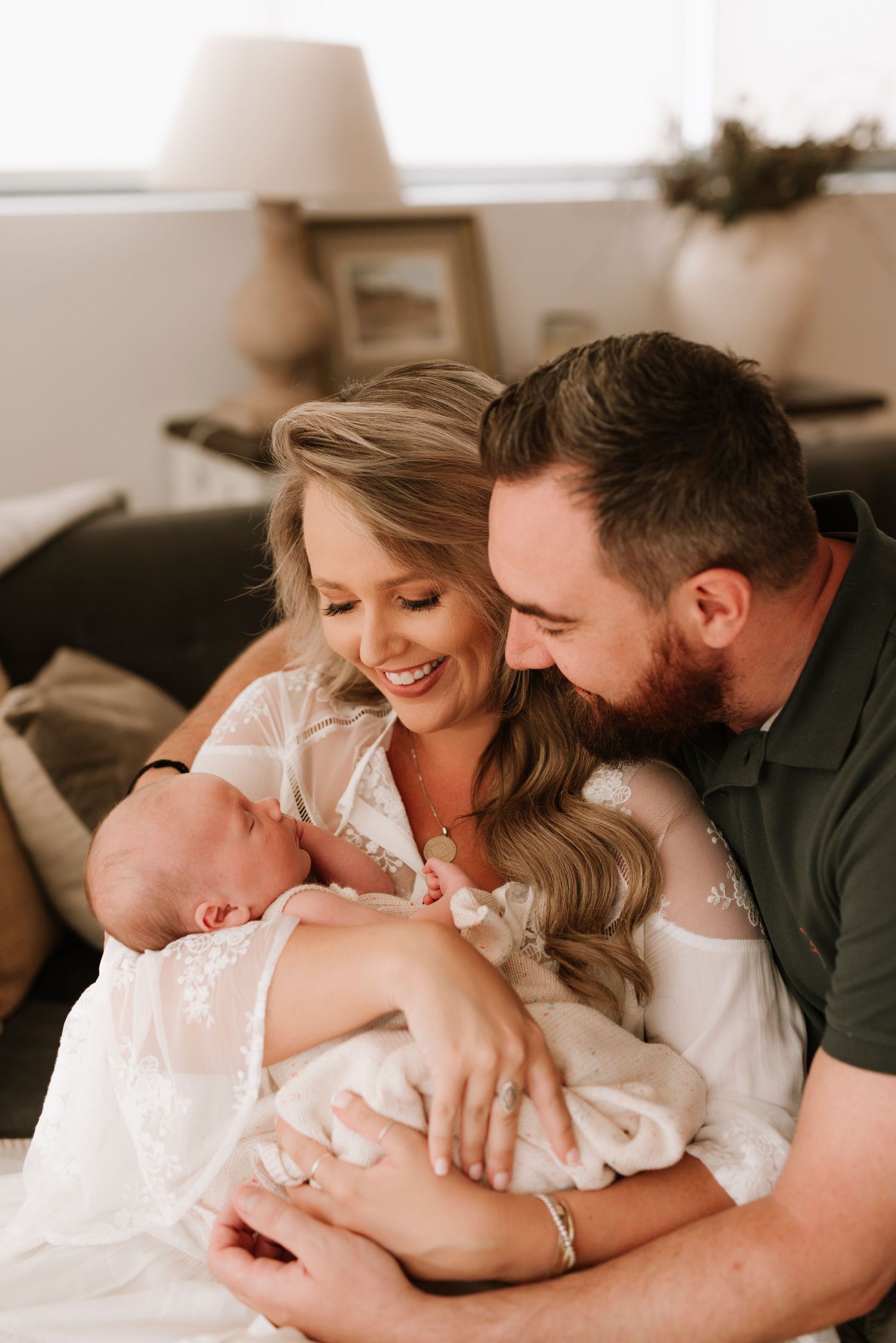 Turramurra newborn photography of parents holding baby in relaxed in-home setting