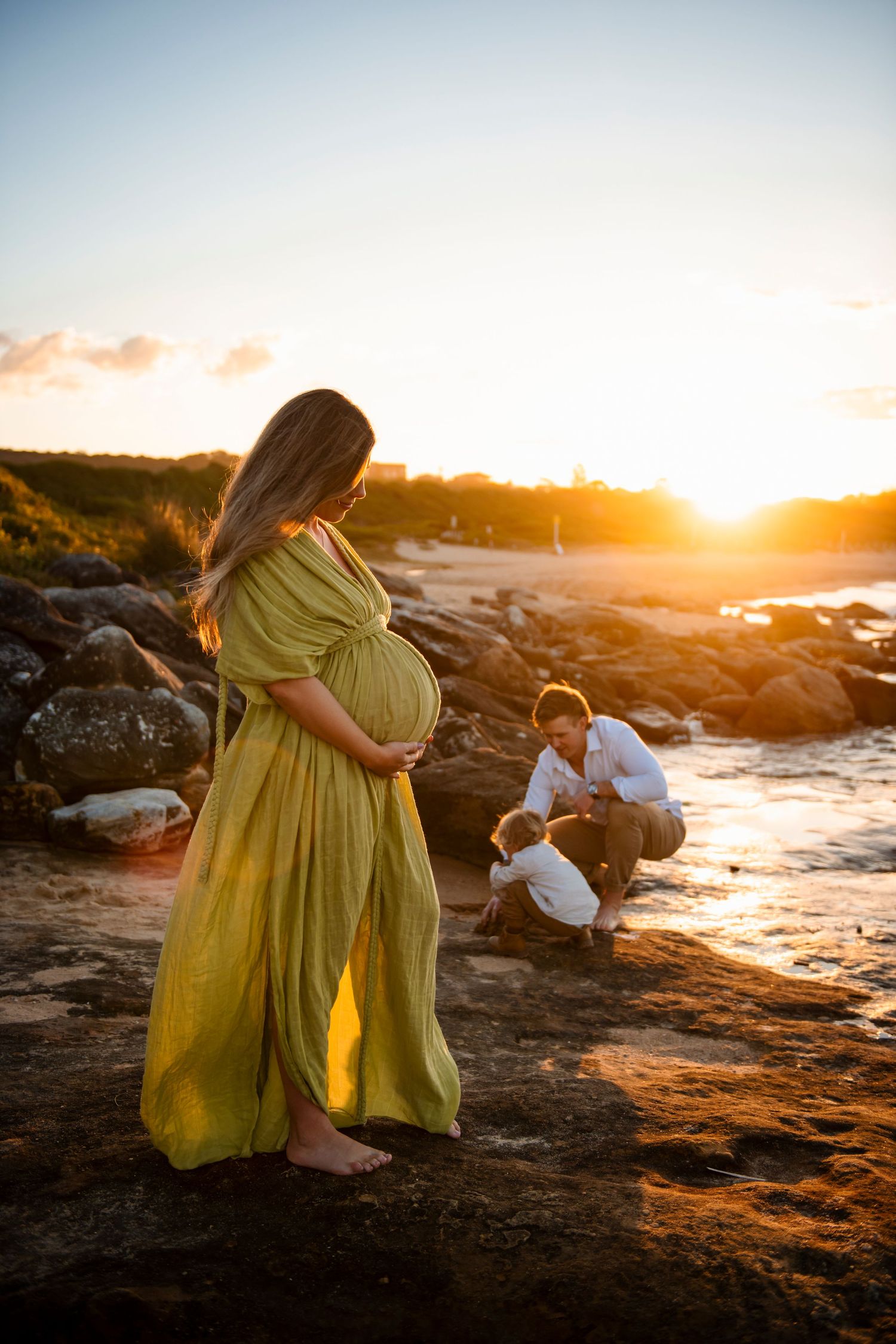maternity photography Maroubra Sydney sunset beach pregnant woman family natural lifestyle session. Mother wearing a gown from Mamarentals