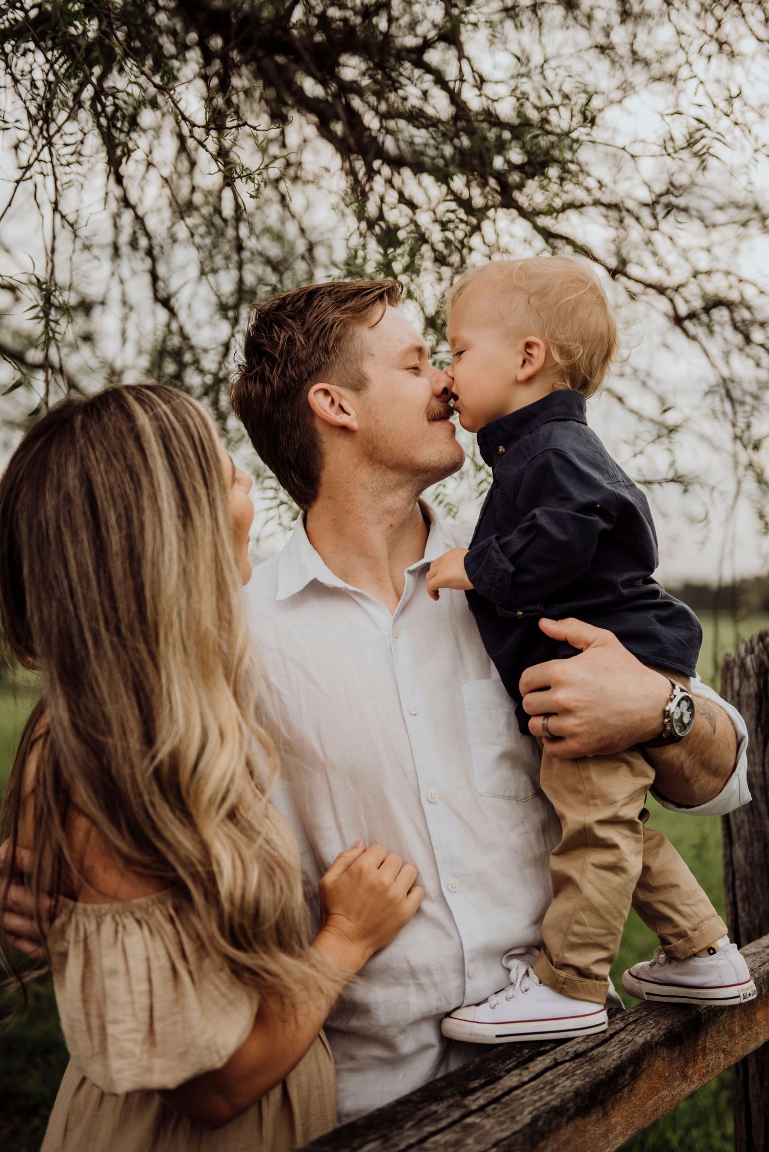 Camden family photography of father holding child while mother stands close