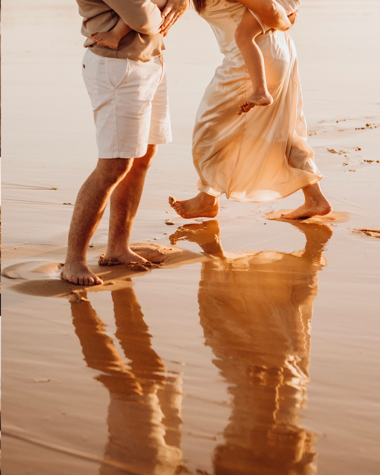 Northern Beaches family photography of parents playing in the water with children in warm evening light