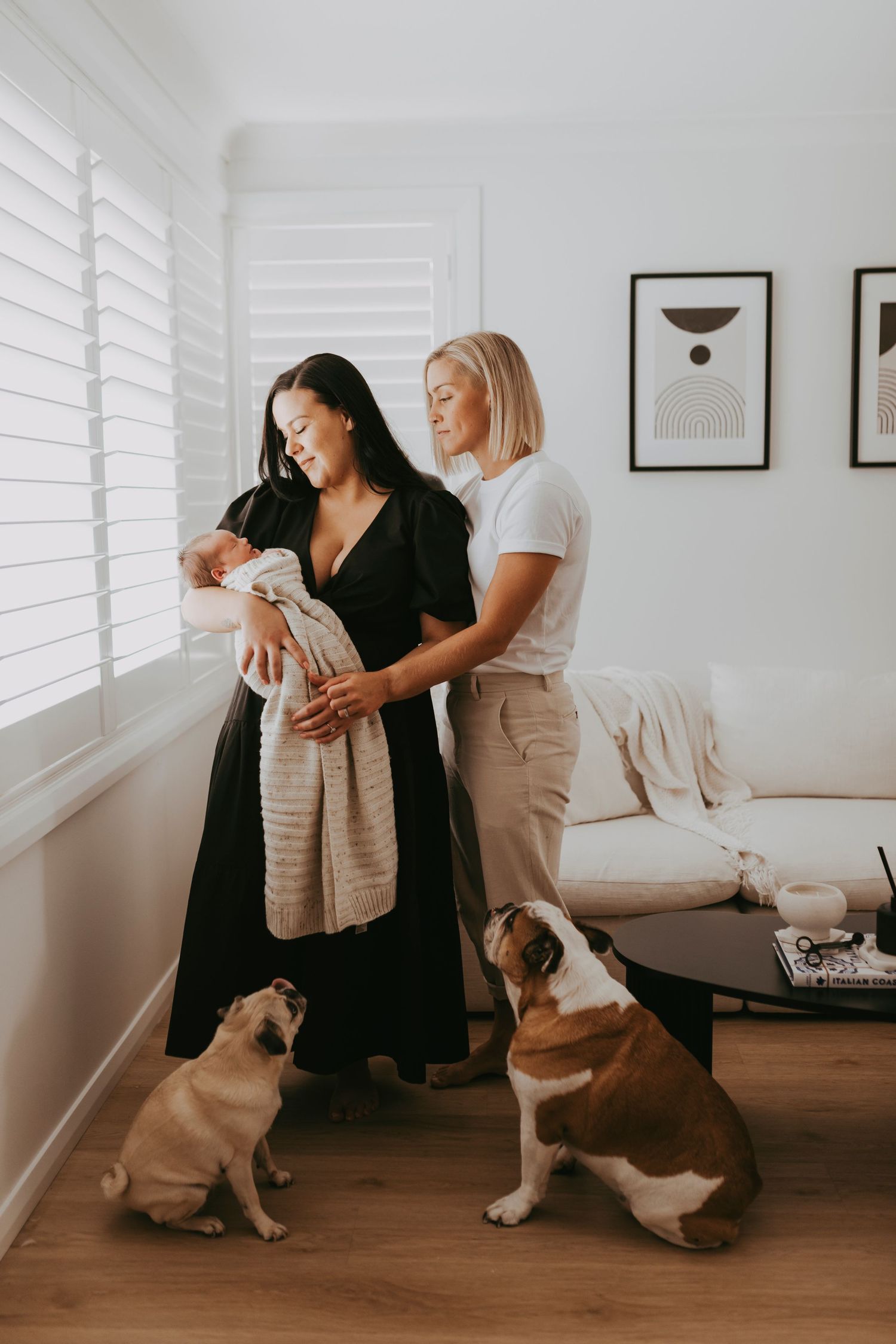 in-home newborn photography Sydney of two parents holding their newborn baby, conceived through reciprocal IVF