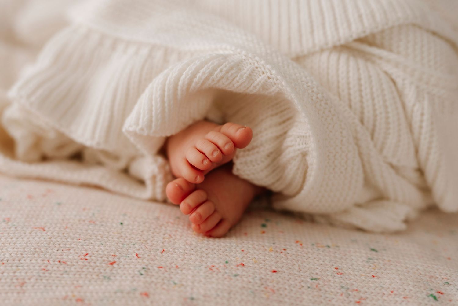 Sydney newborn photography detail of tiny baby toes wrapped in a soft knit blanket