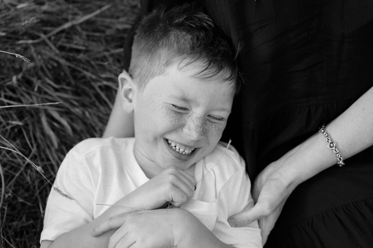 Black and white portrait showing joyful laughter and natural expressions.
