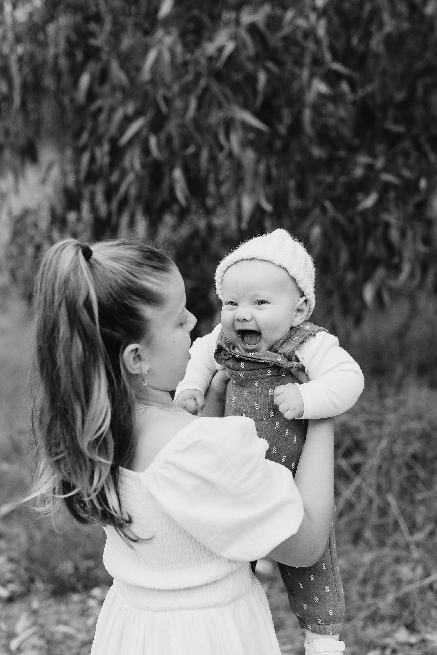 A black and white portrait of pure joy and connection between two people outdoors.