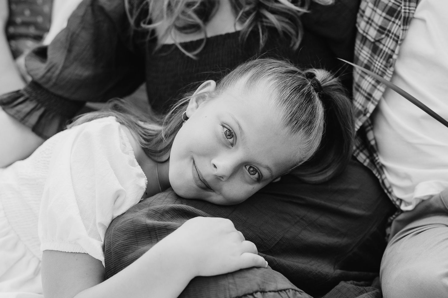 Black and white close-up portrait during intimate outdoor family photo session.