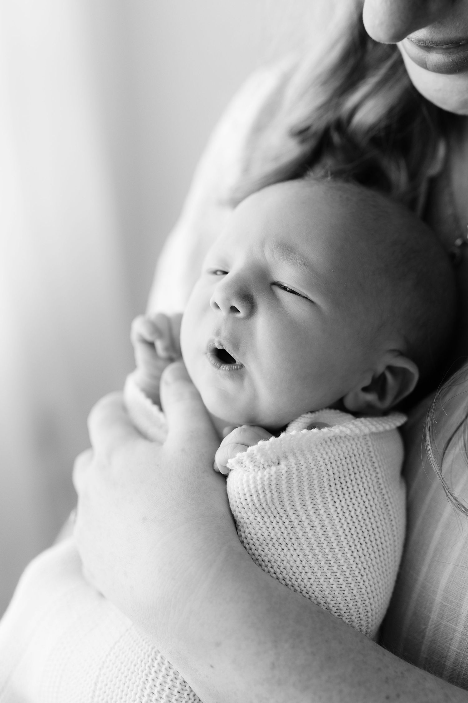 Intimate black and white portraits of a sleeping infant.