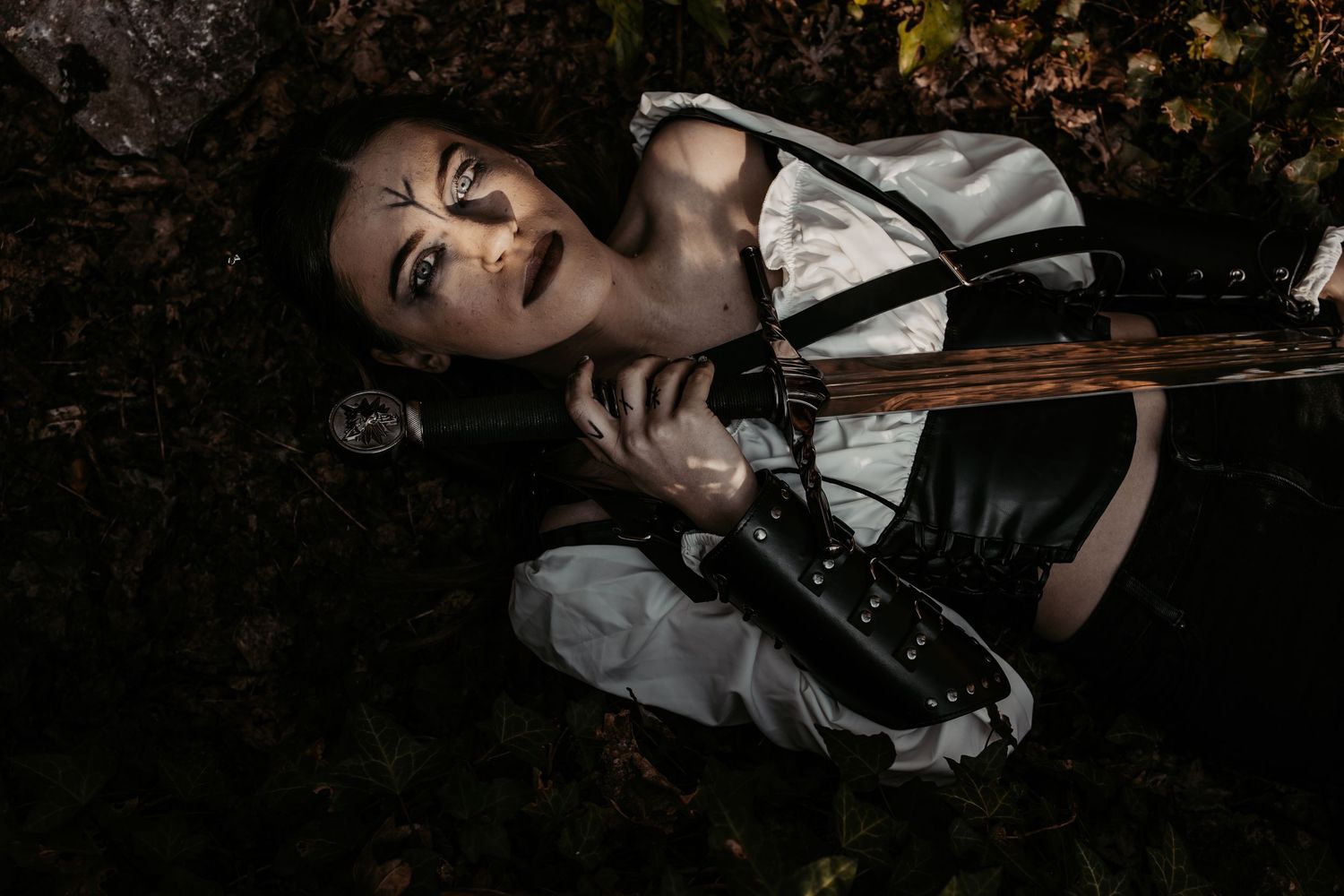 Moody portrait in dark woodland setting with vintage attire.