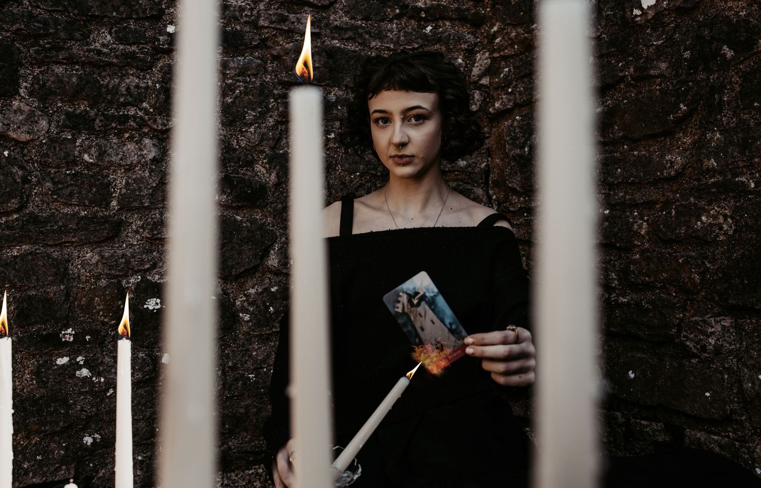Gothic style portrait through iron bars creating dramatic shadows and contrast.