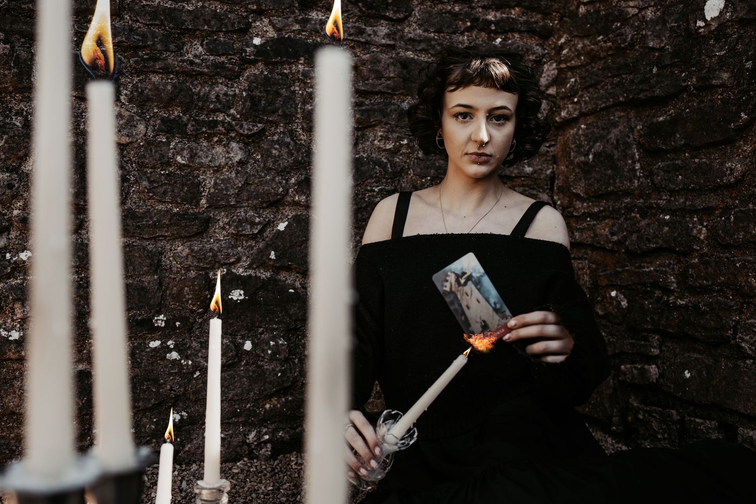Gothic scene with candlelit columns and dark atmosphere.