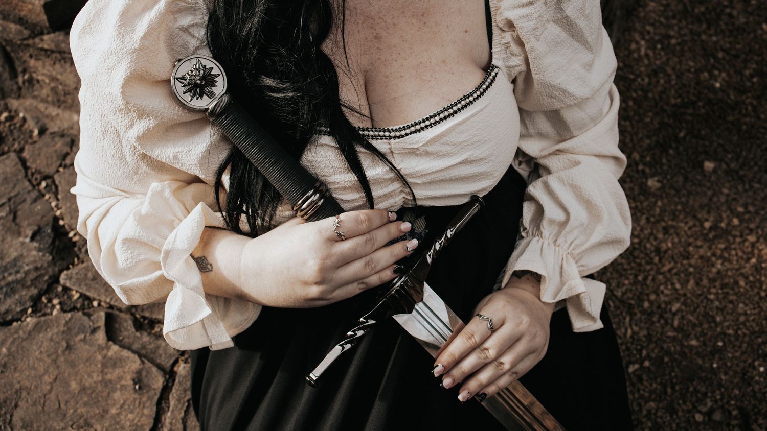 Close-up details of vintage white blouse with black corset styling.