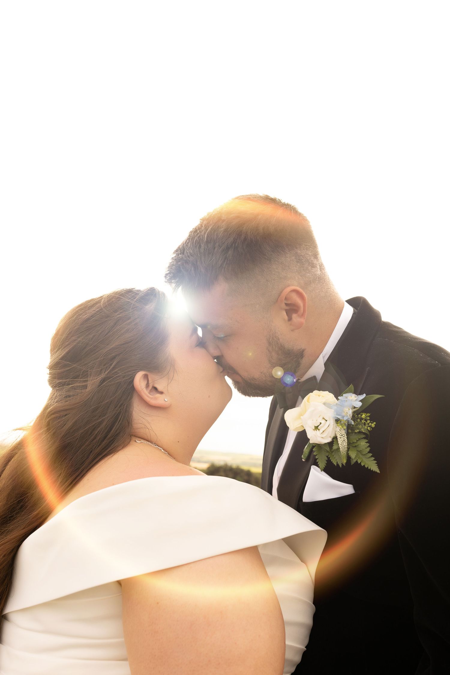 A series of intimate wedding portraits captured with dramatic backlighting and lens flare.