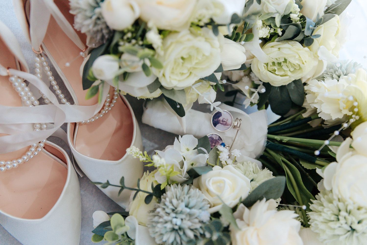 White roses and delicate flowers arranged in an elegant bridal bouquet.