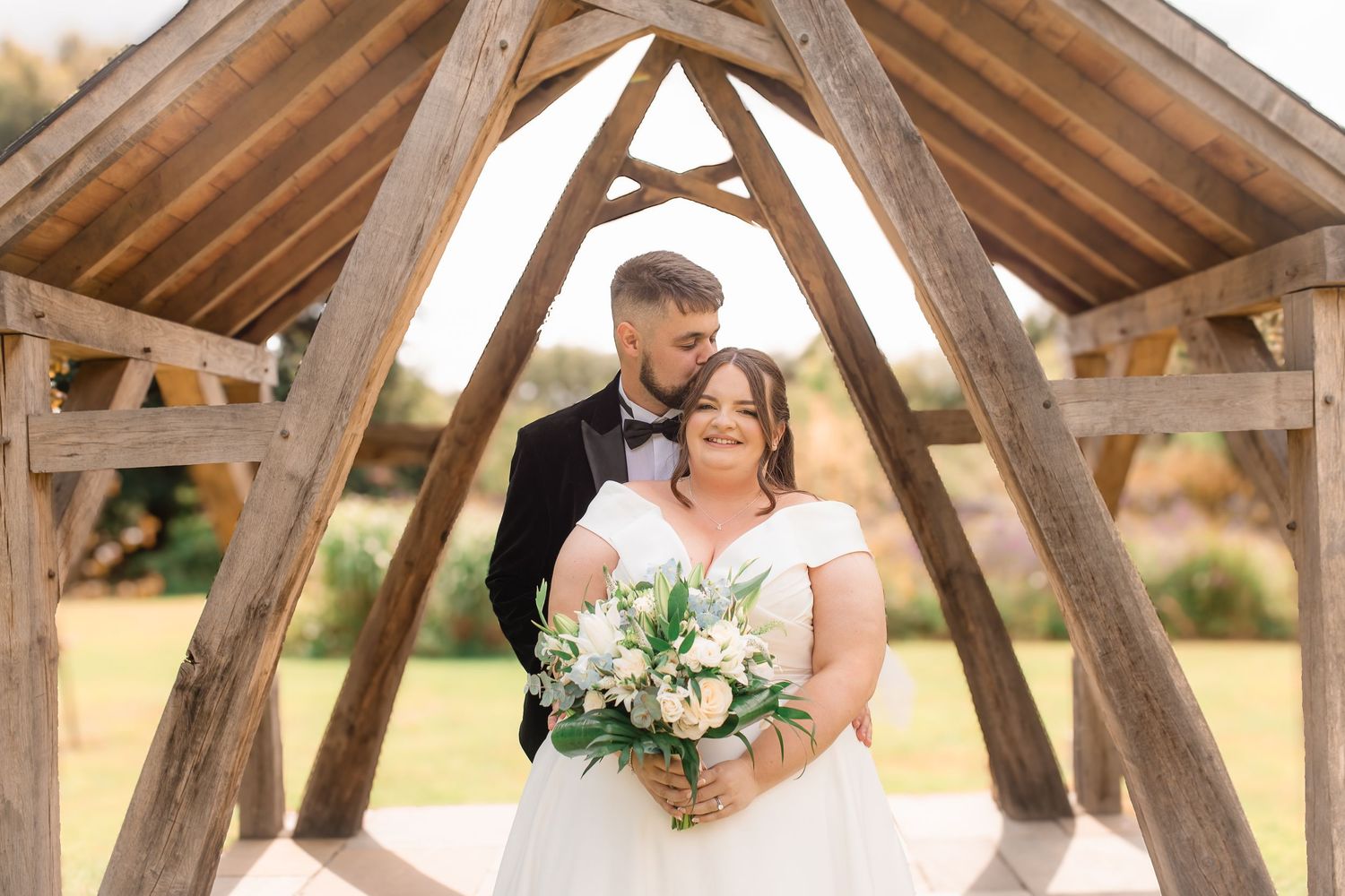 A series of romantic moments captured under a wooden pergola structure.