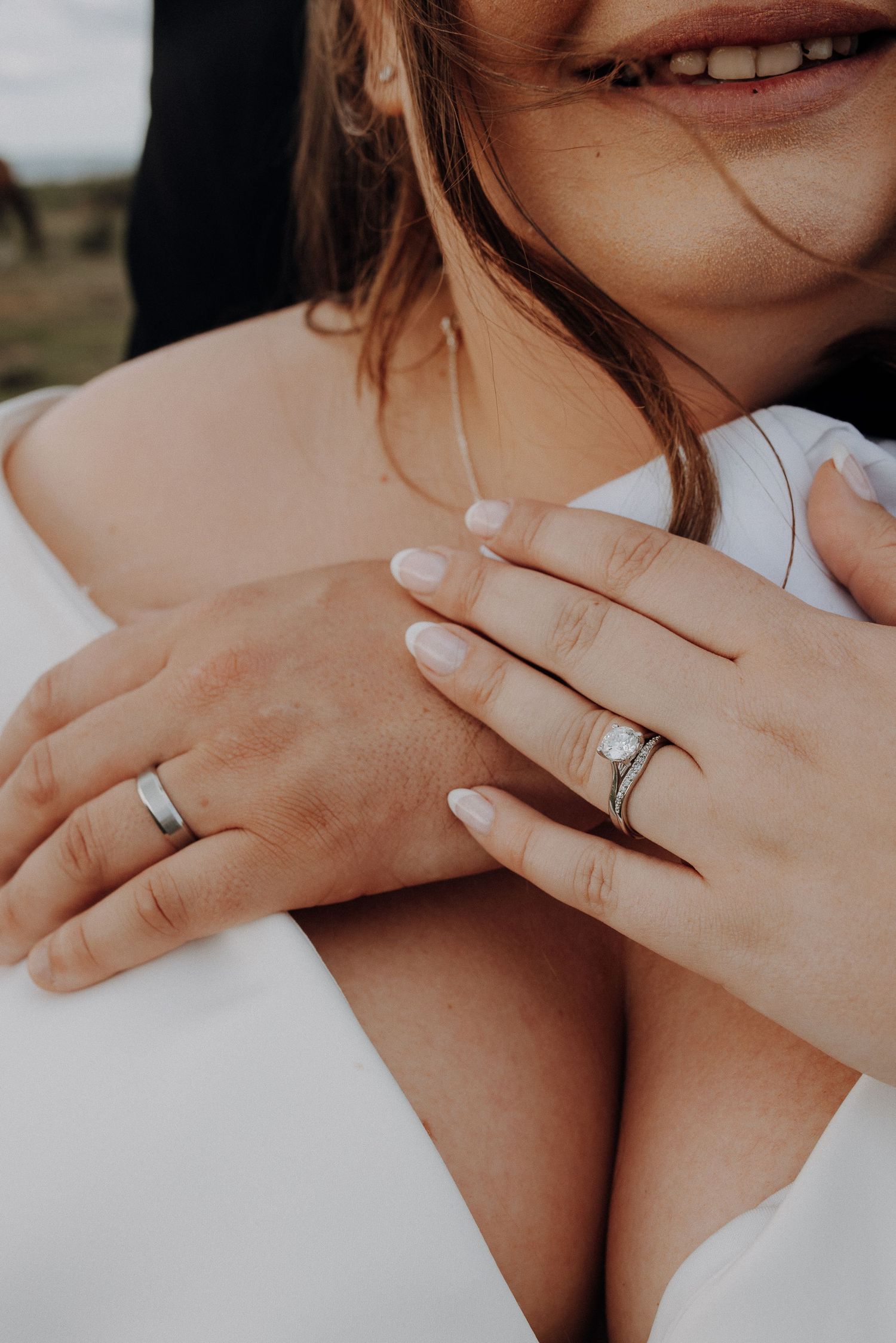 Close-up shots of hands wearing wedding rings against a white background.