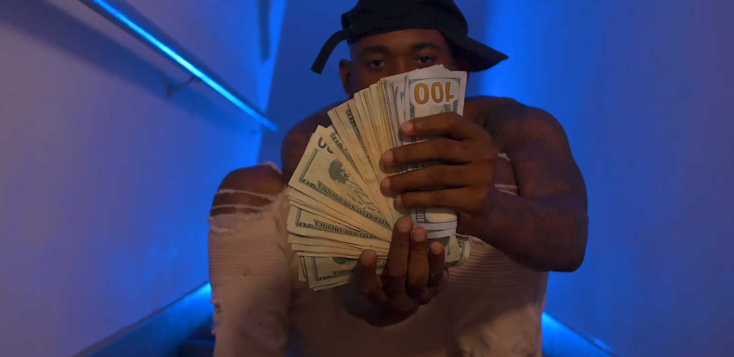 Blue-lit scene showing hands counting cash money.