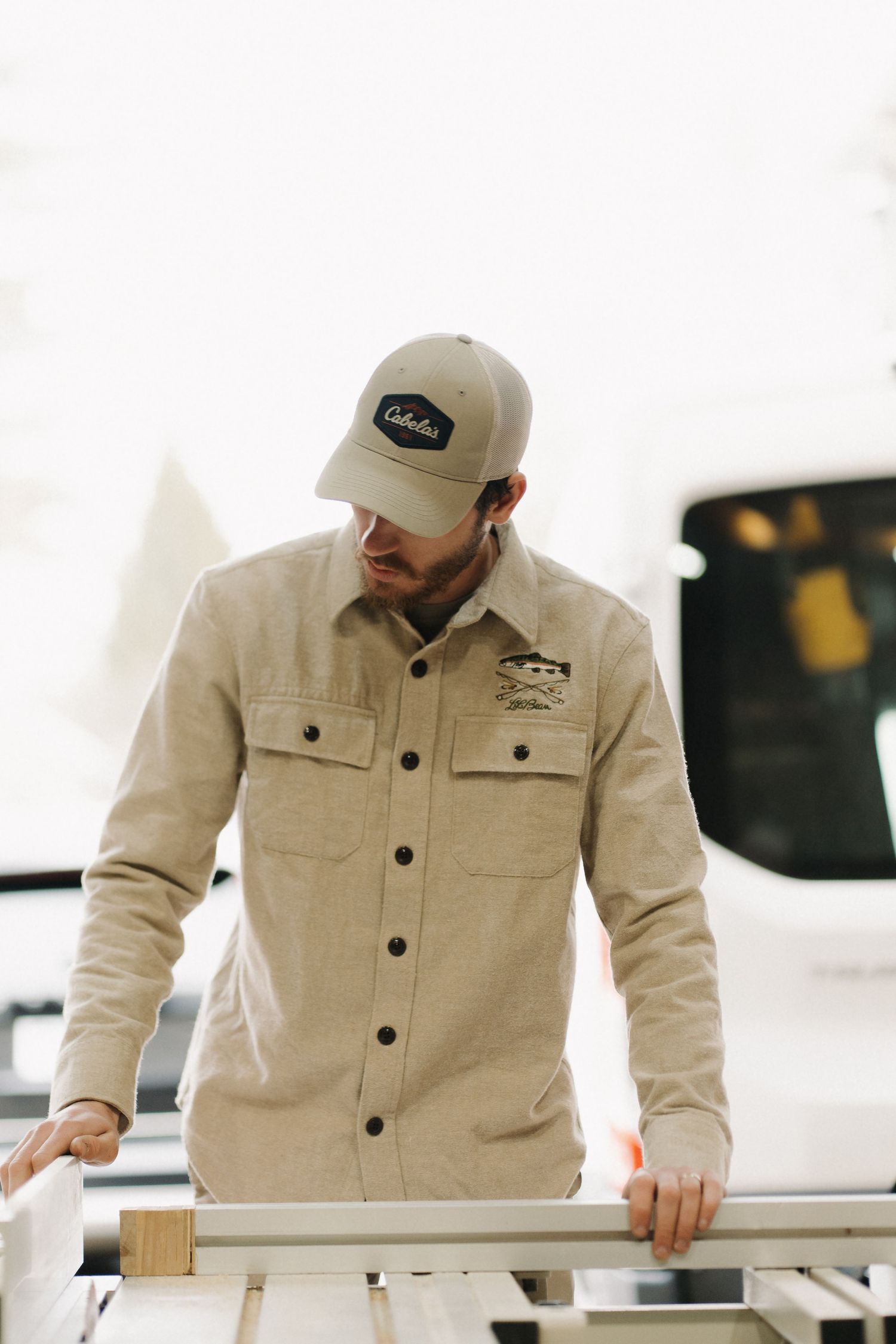 Construction worker in beige workwear examining project details.