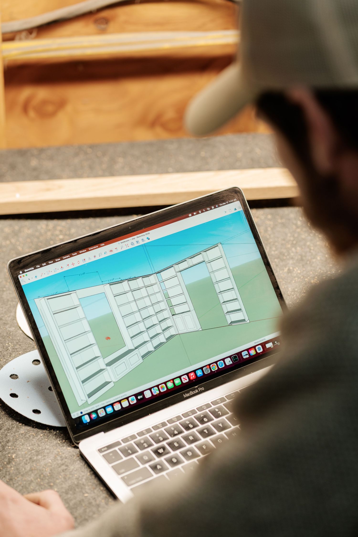 Computer screen displaying 3D architectural design software in a workspace setting.