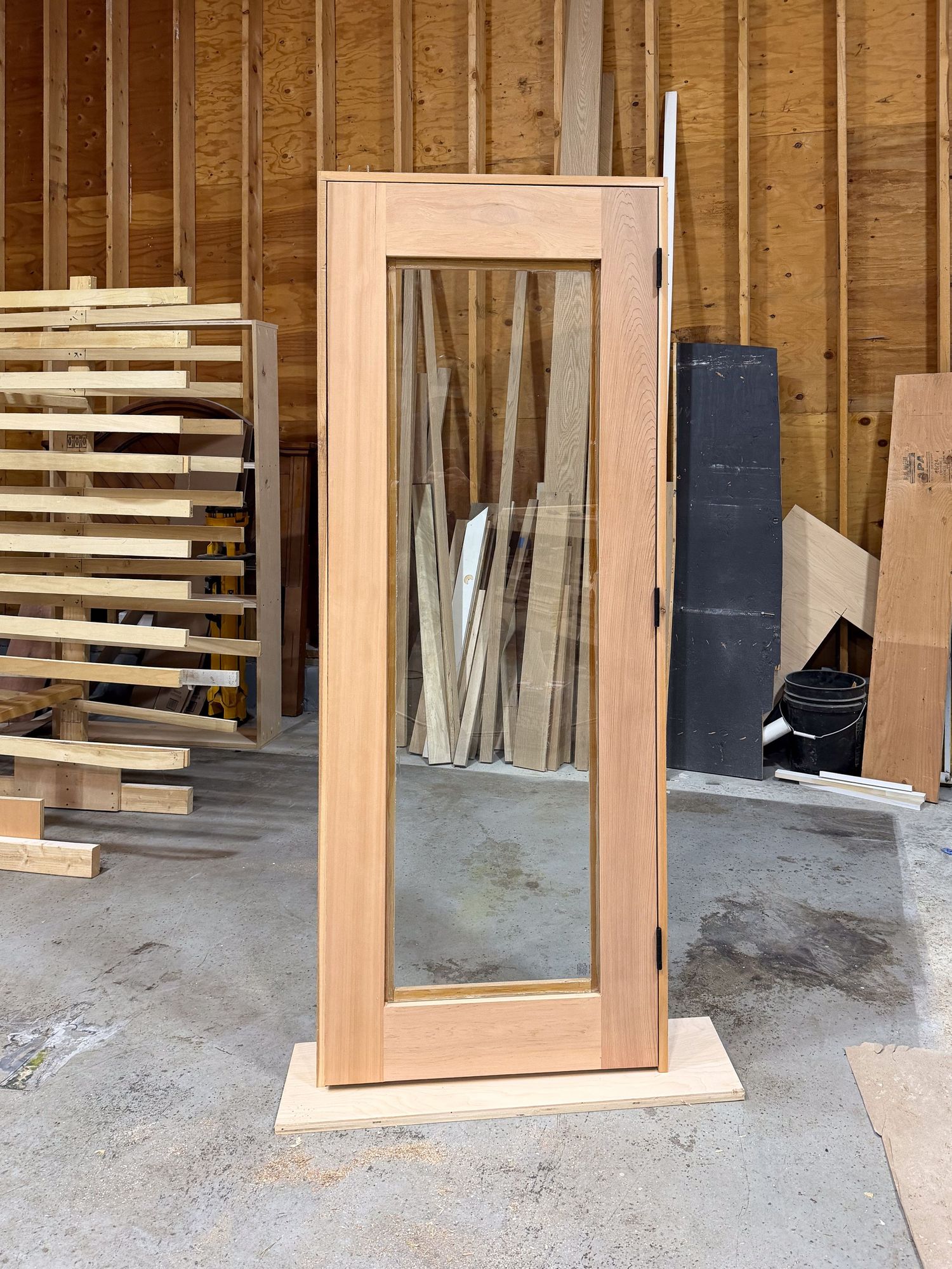 Unfinished basement construction area with exposed wood framing and window installation.