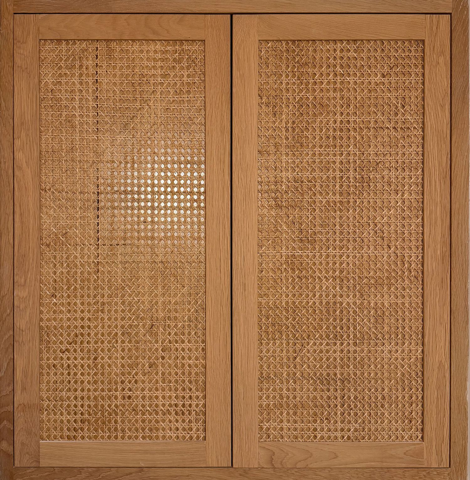 Double-door cabinet with woven cane mesh panels in natural wood finish.