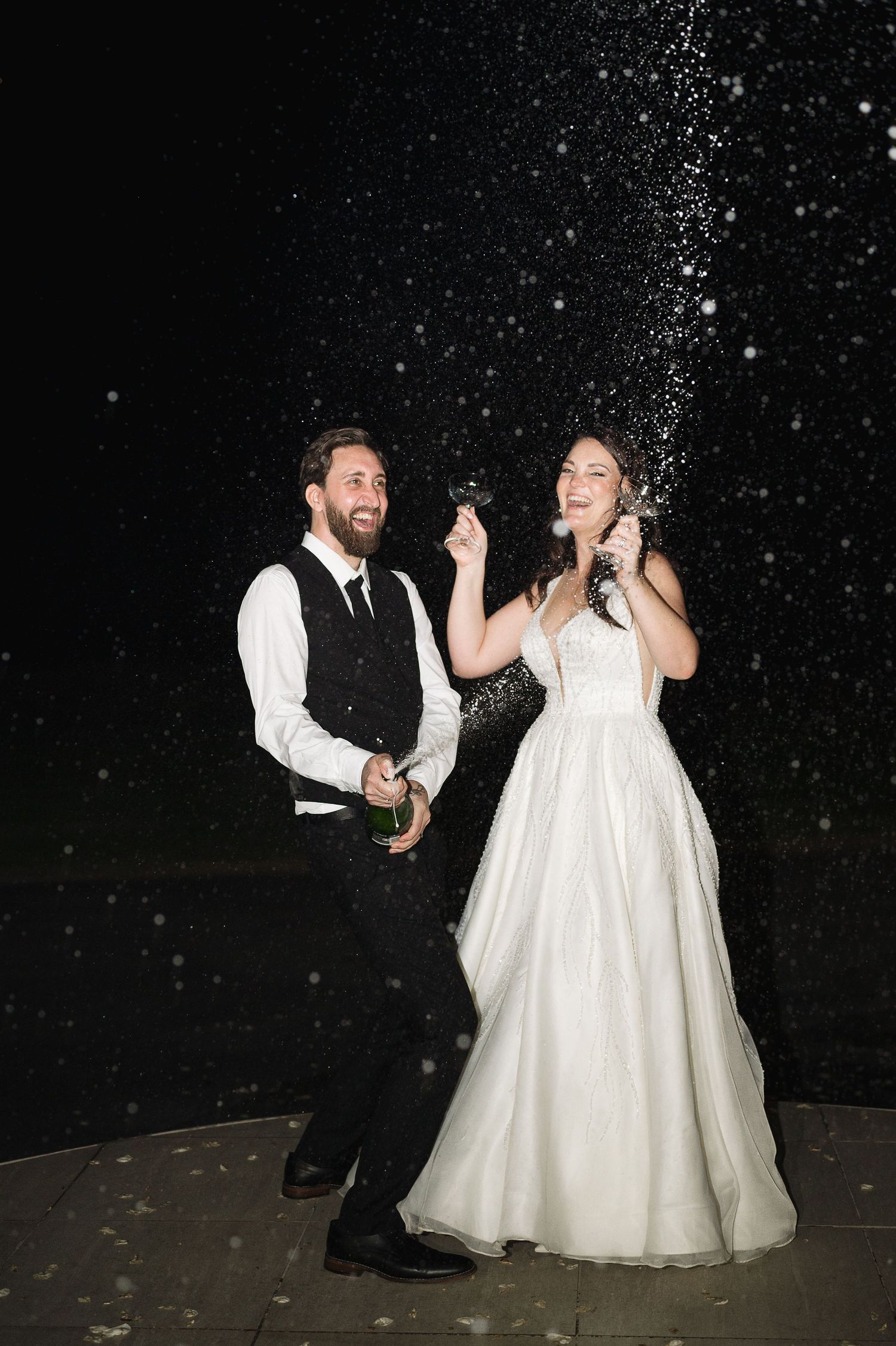 Bride & Groom spraying champagne. Flash, editorial style. Cape Town wedding.