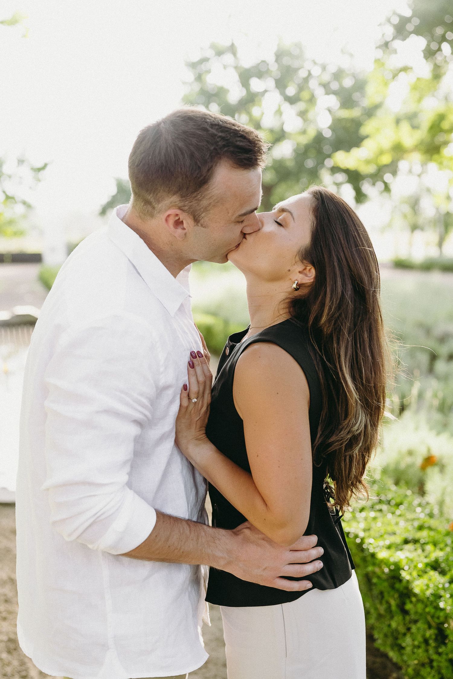 Newly engaged couple walking in the beautiful gardens at La Paris, Franschhoek.