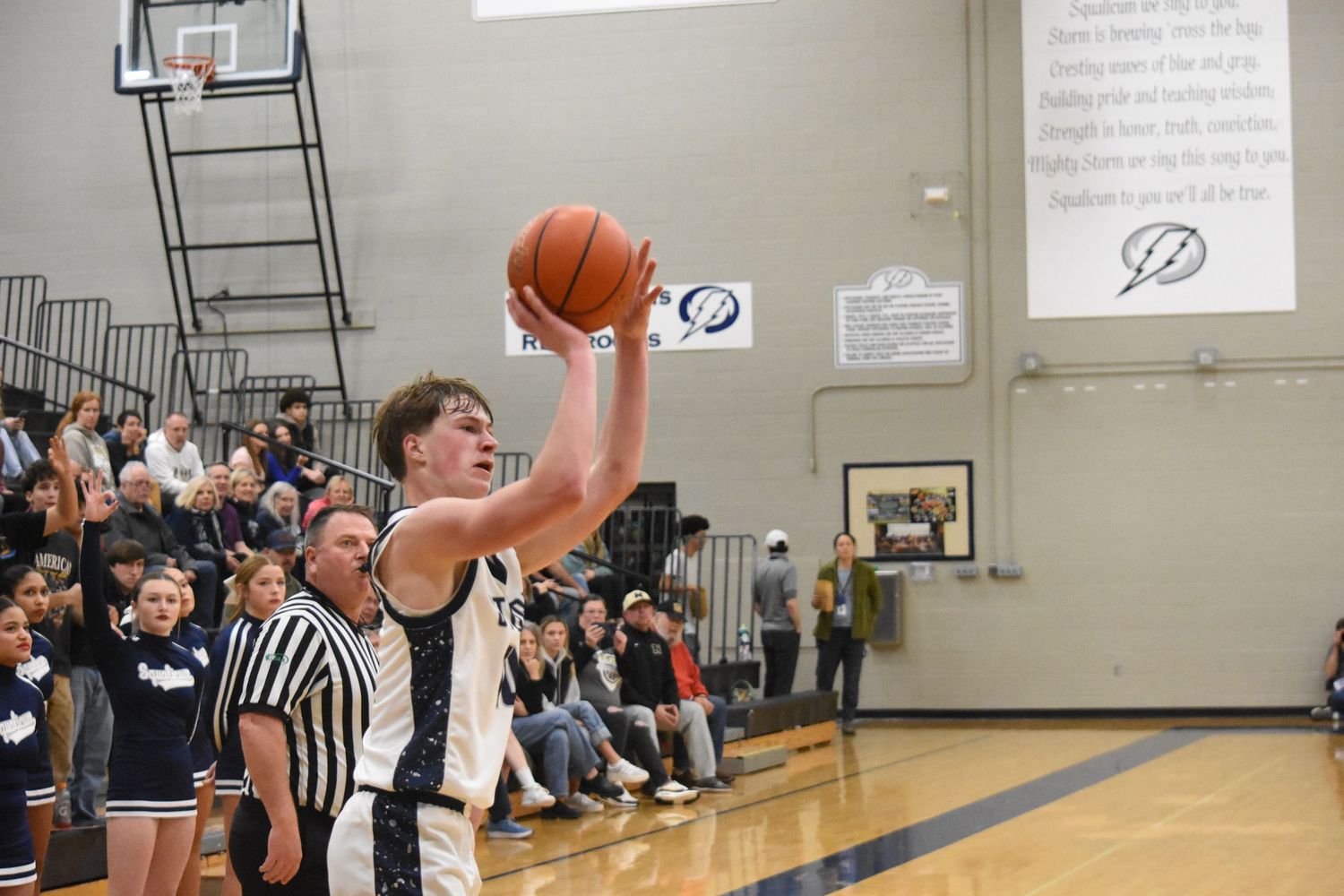 Player attempts three-point shot from corner during basketball game.
