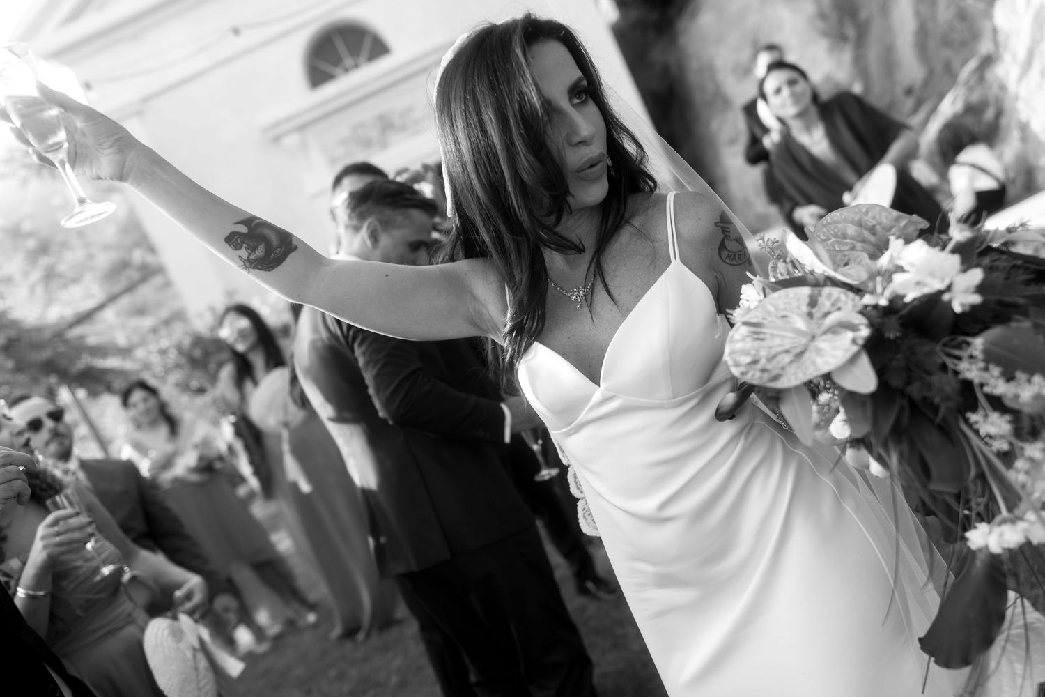 Black and white photo showing a bride on the dance floor during a wedding reception celebration.