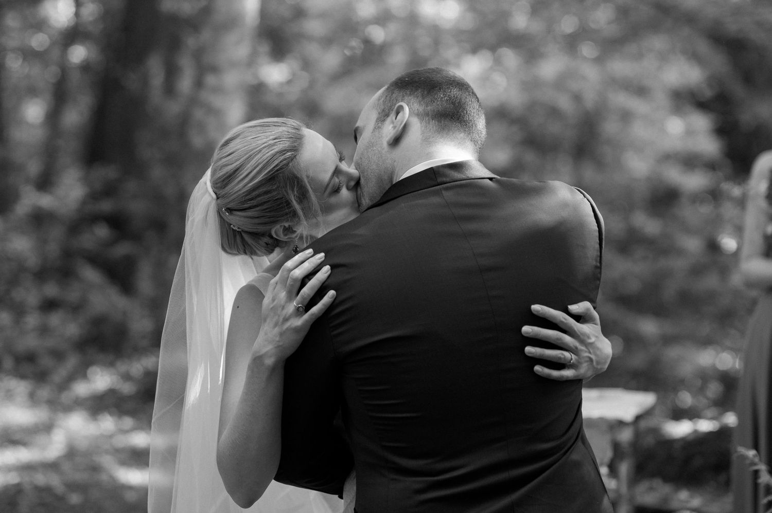 A series of romantic black and white wedding photographs showing intimate moments between newlyweds in an outdoor setting.