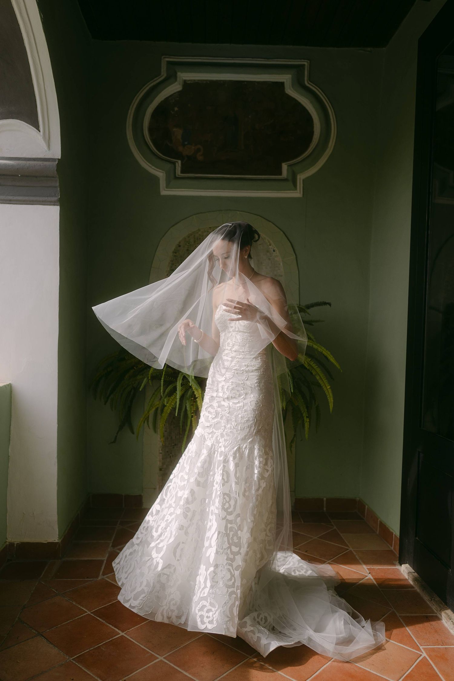 A series of wedding dress photos showing graceful twirling movement against a dark interior with terracotta floor tiles.