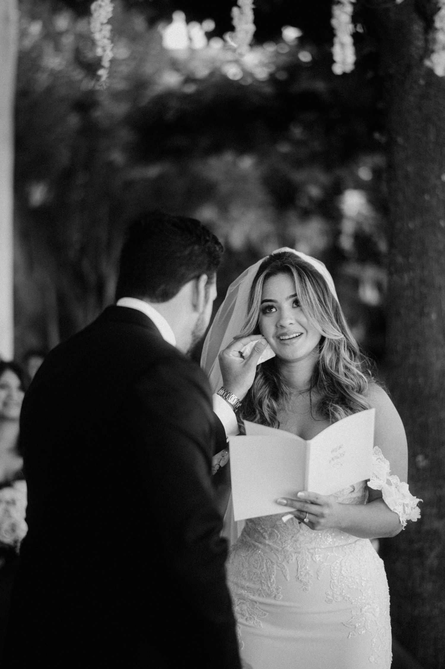 A romantic black and white photo sequence shows a couple sharing tender moments while cutting their wedding cake together.