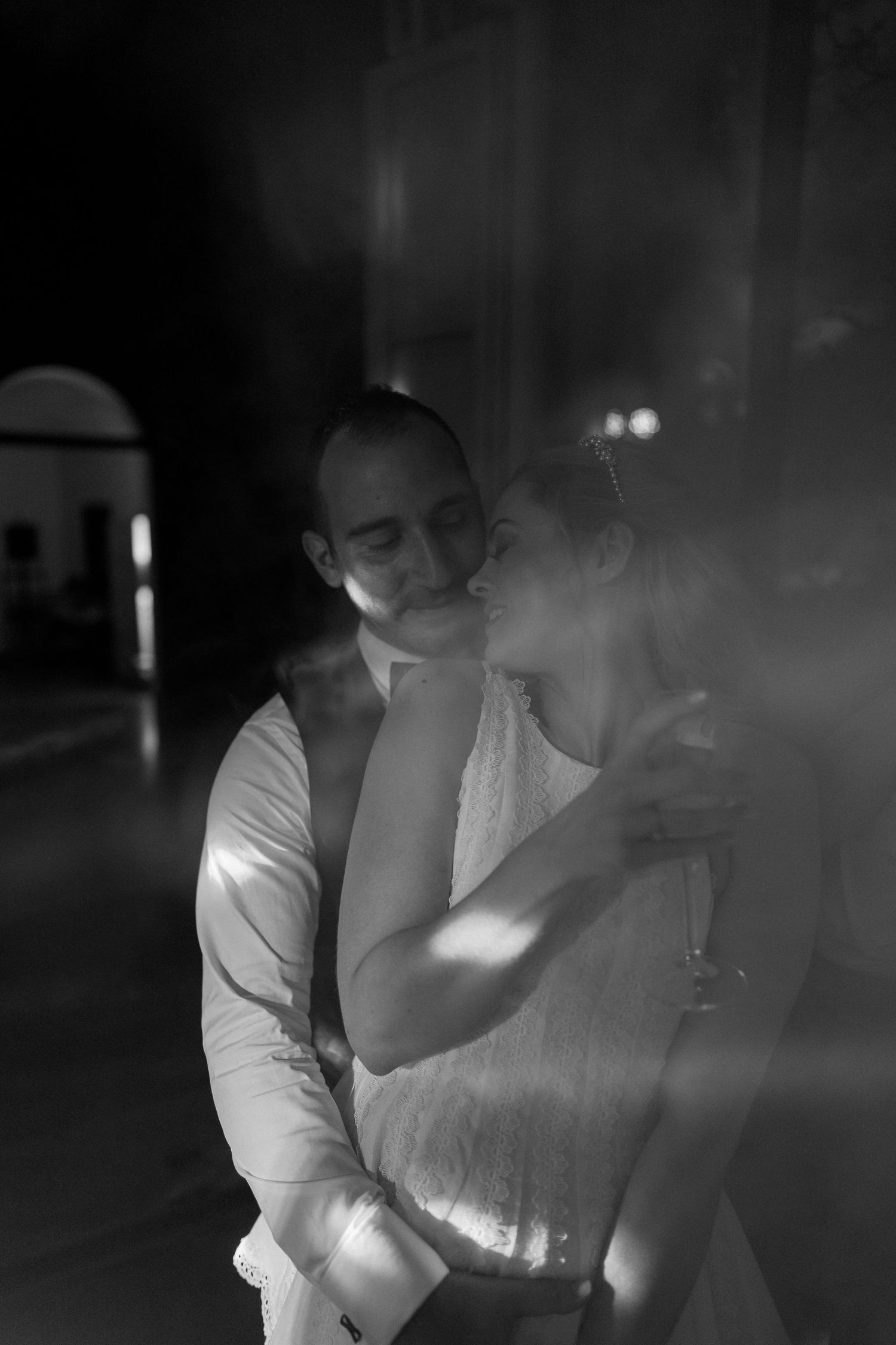 A romantic black and white photo sequence shows a couple embracing in an intimate moment with atmospheric lighting.