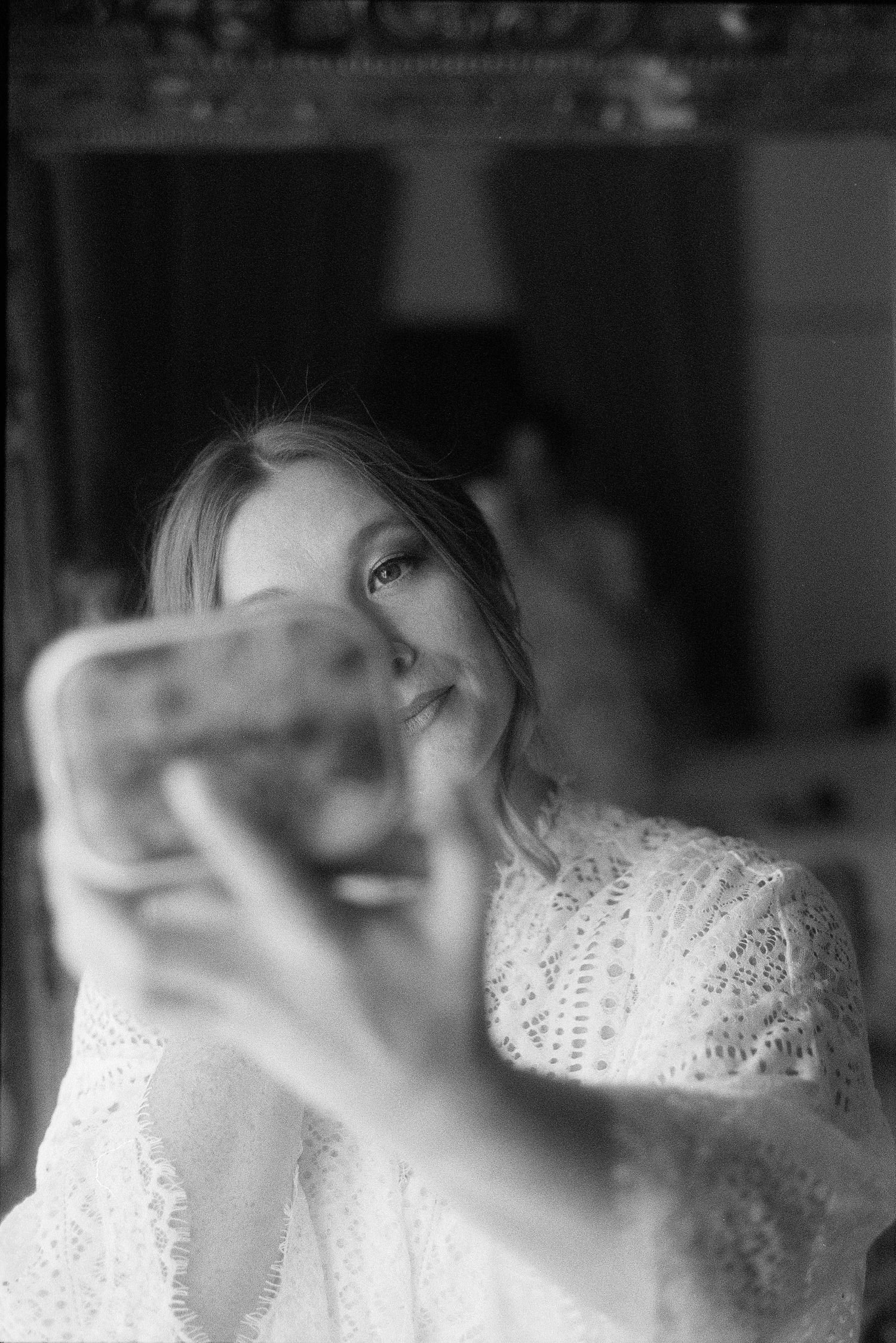 A series of blurred black and white photographs showing abstract shapes and textures with white lace-like patterns.