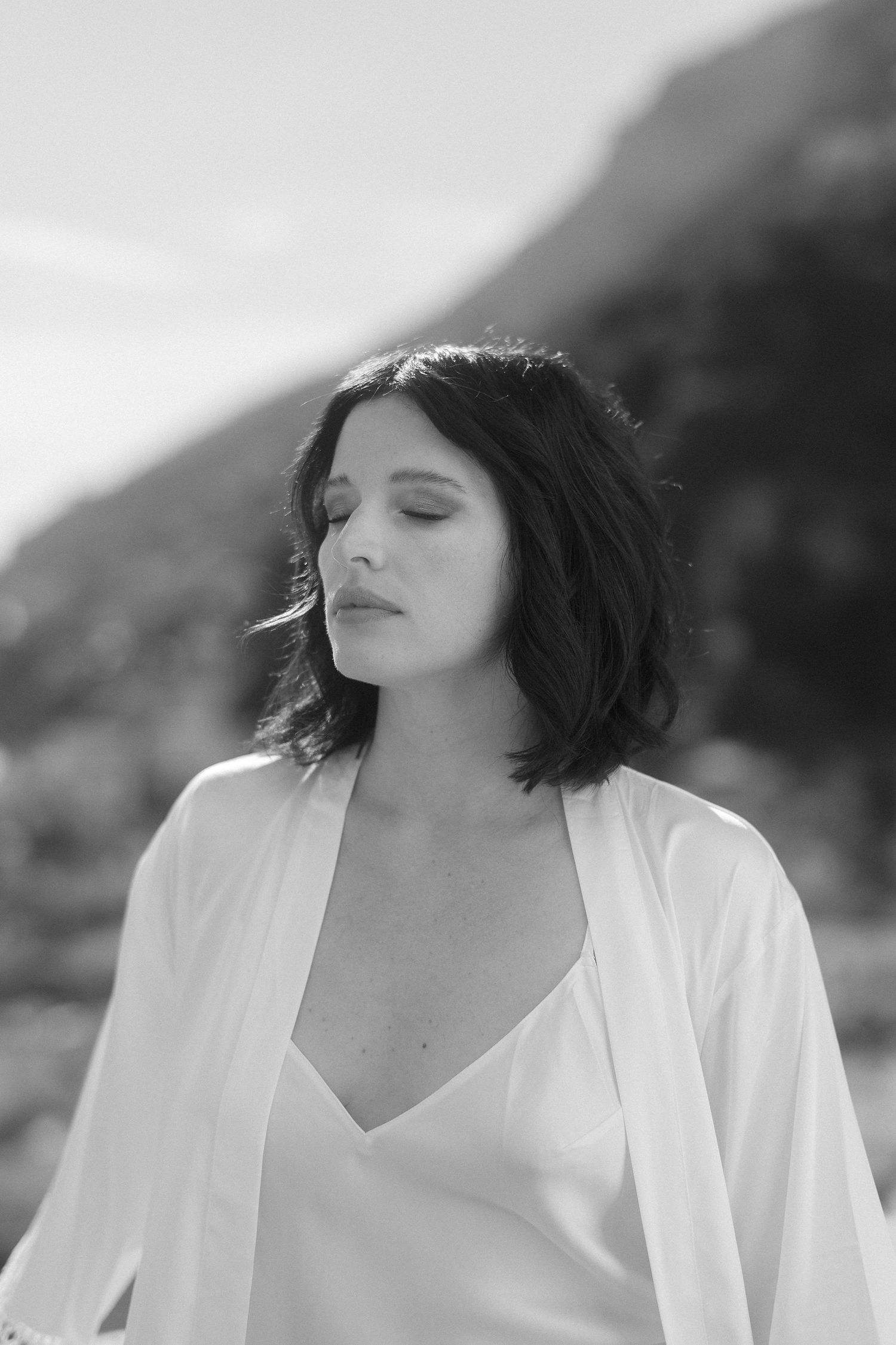 Black and white portrait sequence showing a woman in white clothing with closed eyes against a blurred background.