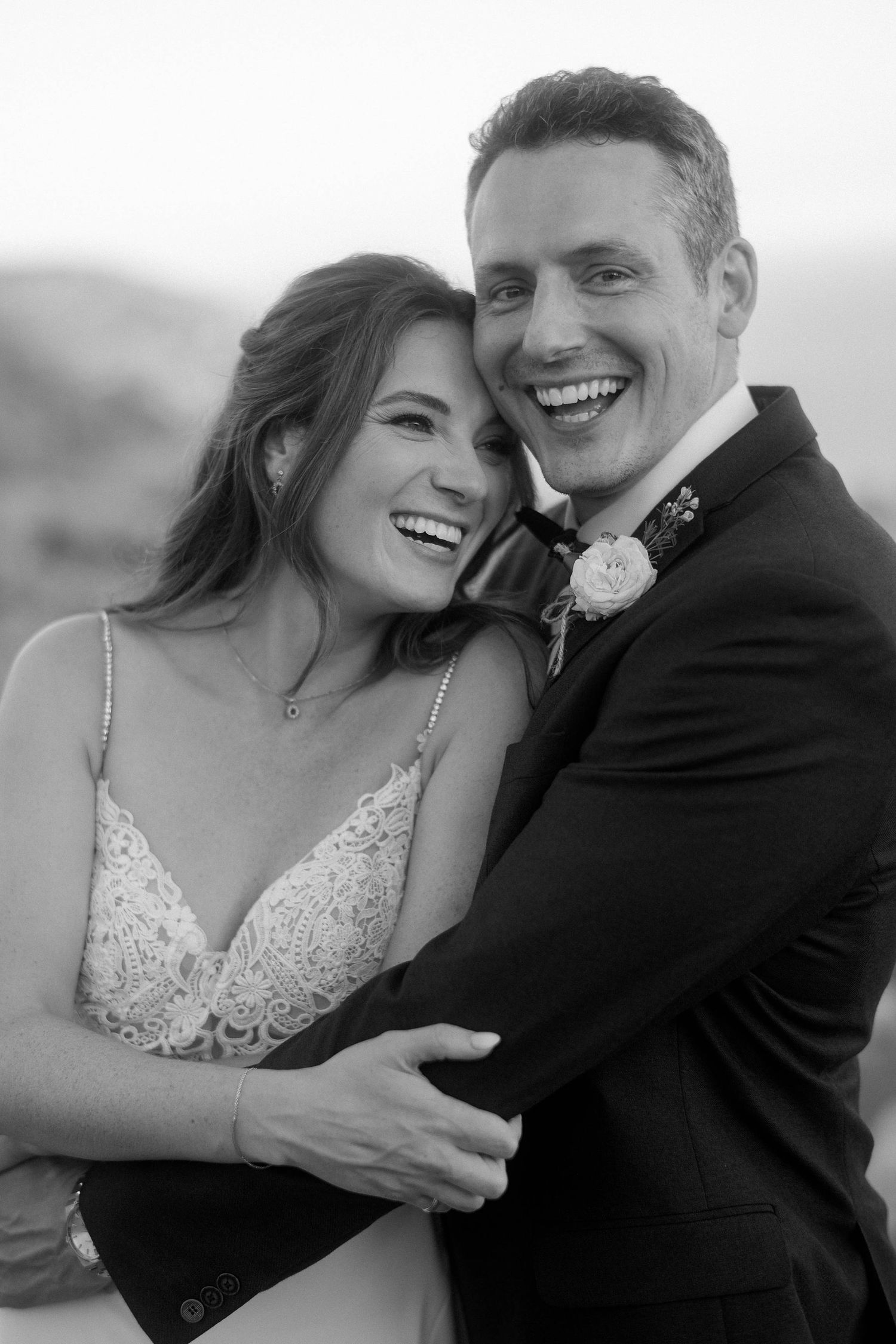 A romantic black and white photo series showing a couple laughing and embracing in joyful wedding moments.