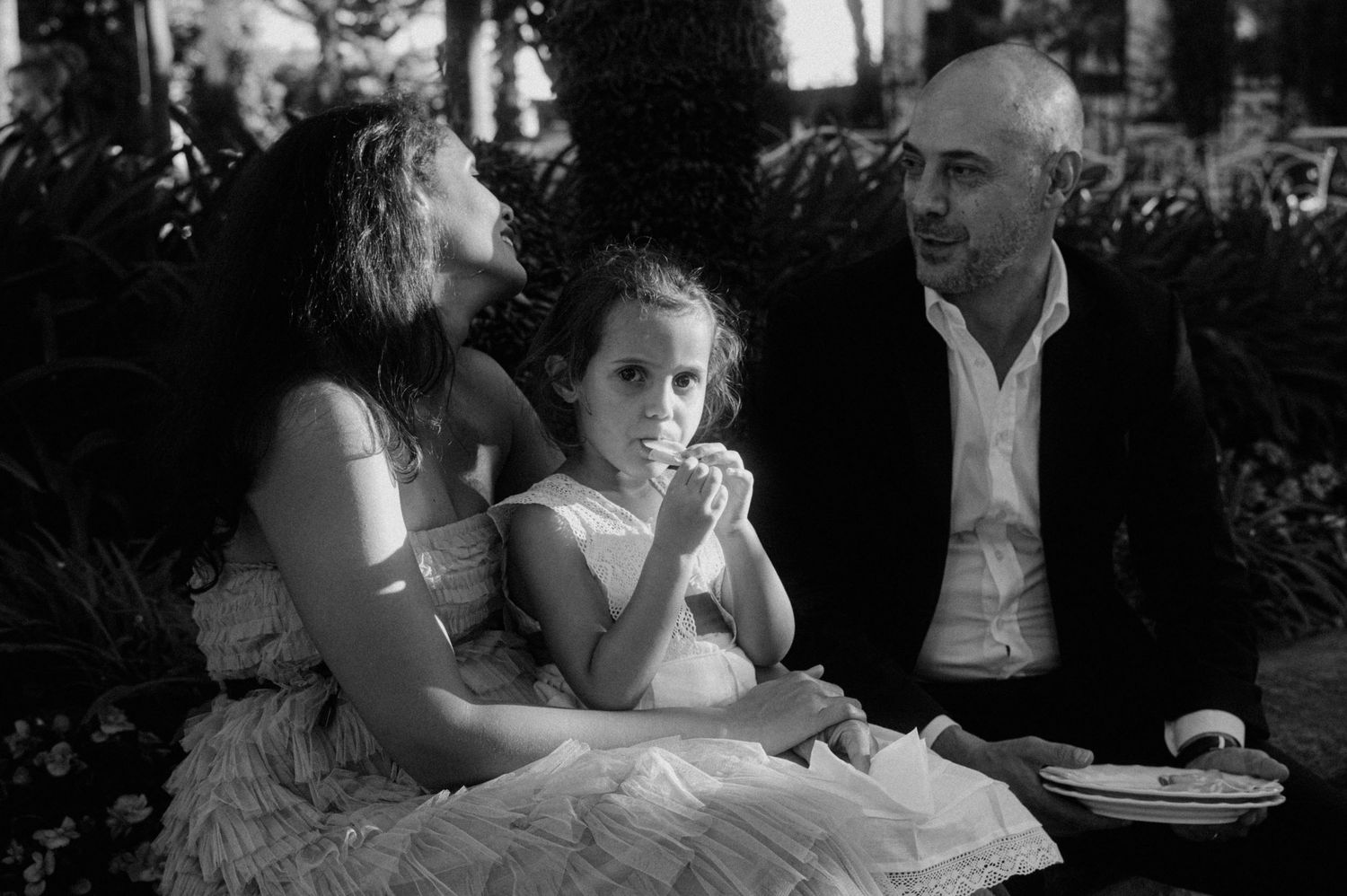 Black and white candid shots of guests celebrating at an evening wedding reception.