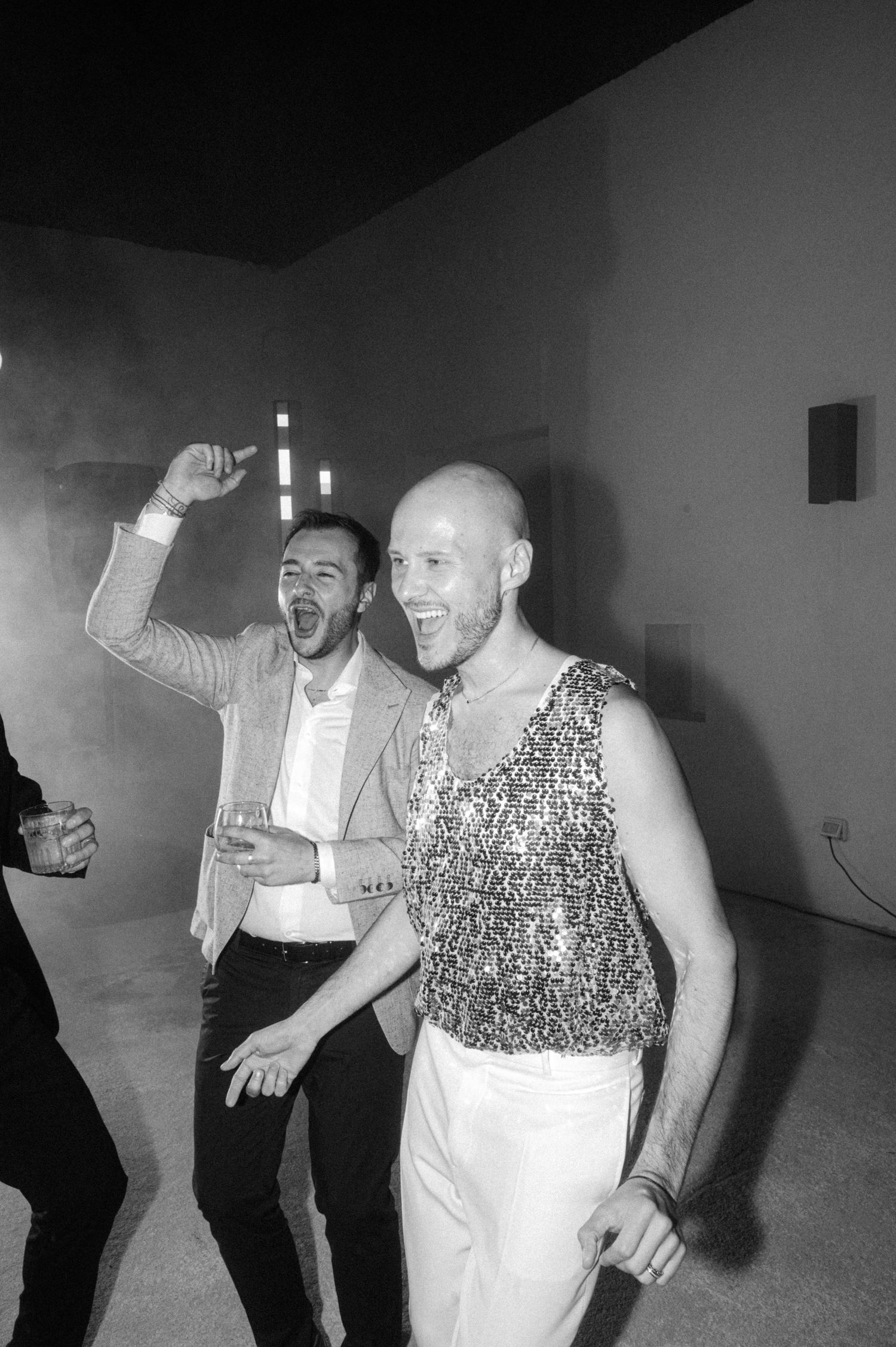 Black and white photo of people dancing and having fun at what appears to be a party or social gathering.