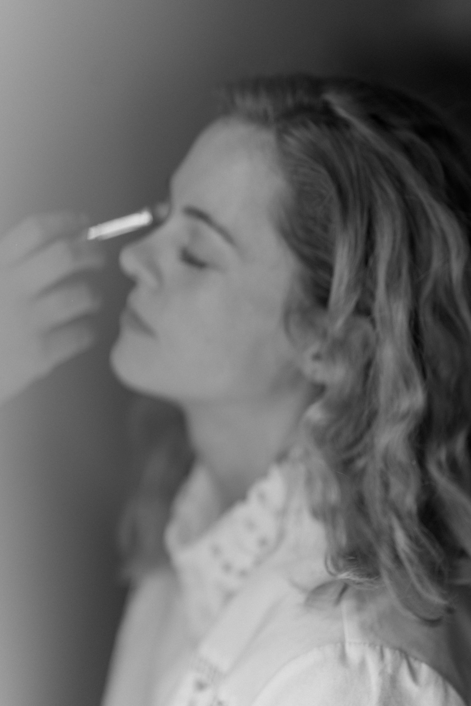 A black and white profile portrait shows a person with wavy hair gazing upward in a dramatic pose.