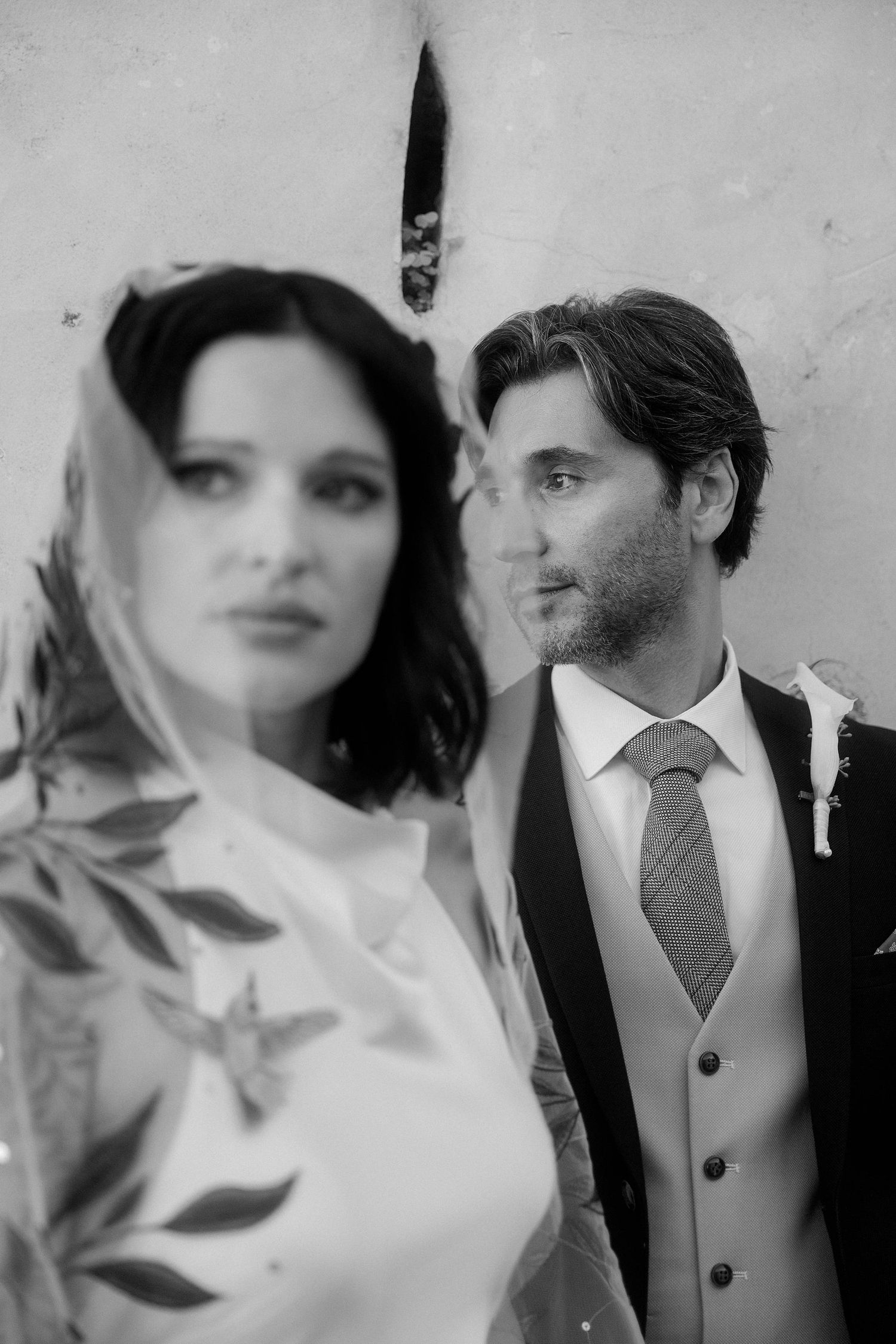 A black and white photo sequence showing close up portraits of a couple in formal wedding attire.