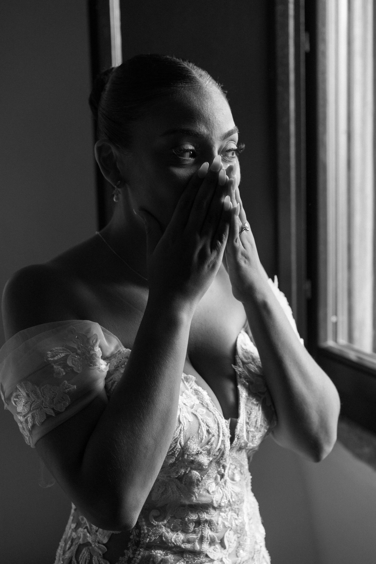 A sequence of black and white photos shows someone in a white lace dress covering their face near a window.