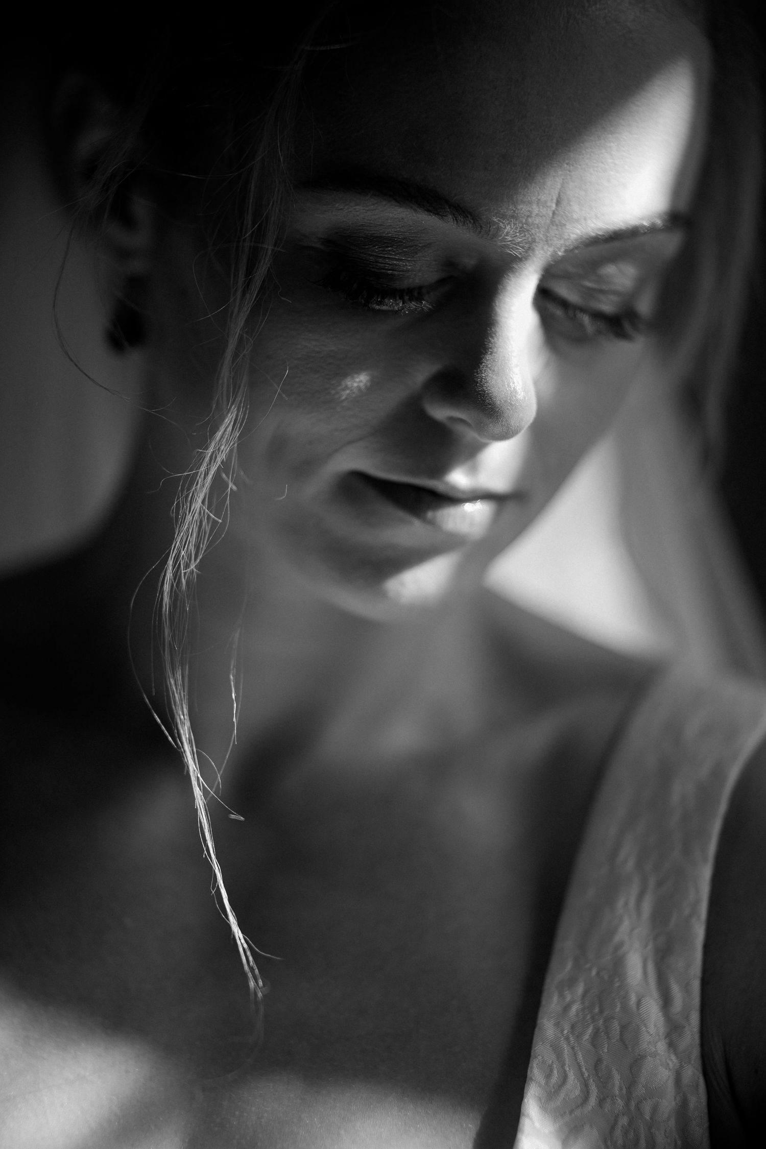 Artistic black and white portrait series showing close-up fragments of a face in dramatic lighting and shadows.